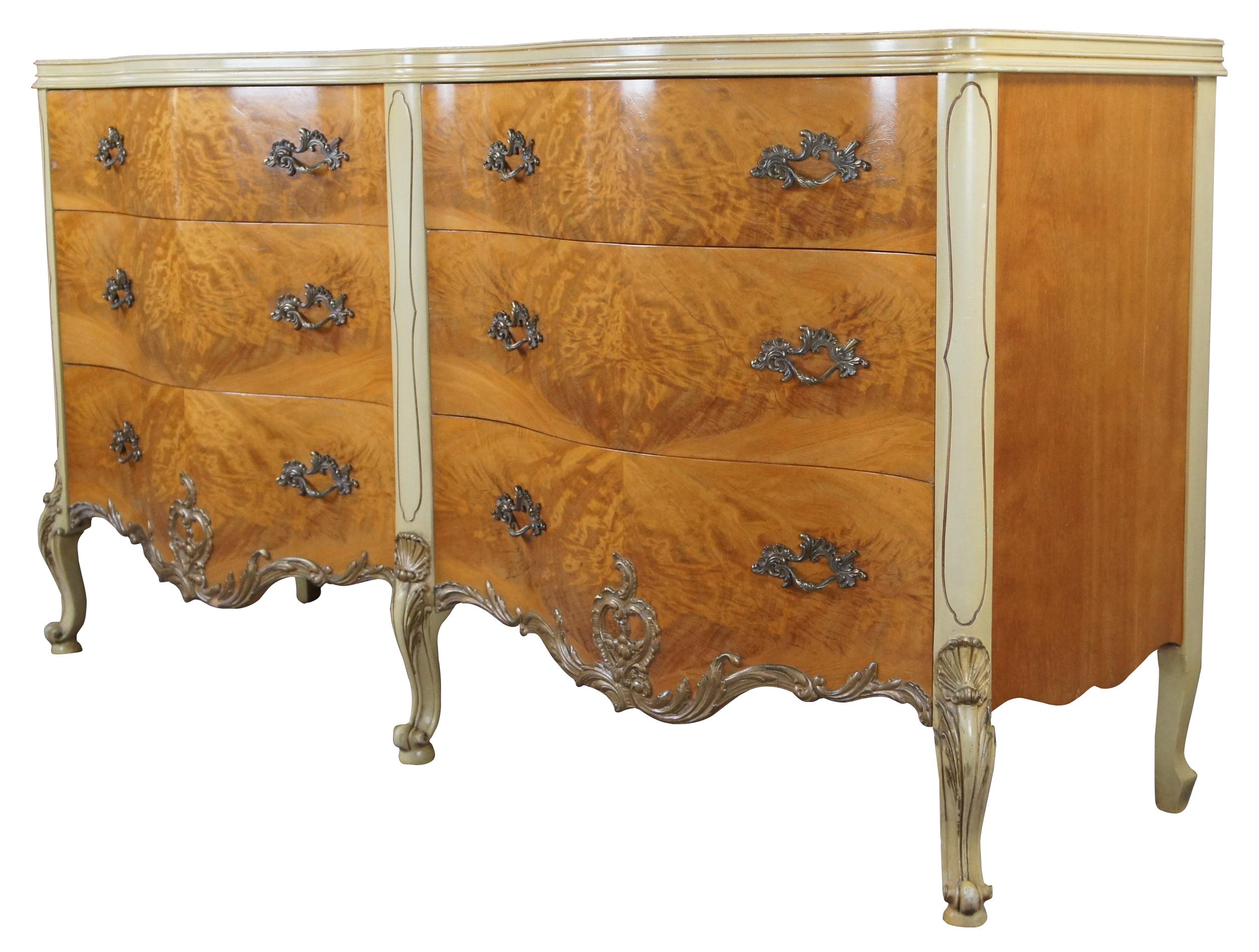 Impressive French inspired double dresser or credenza by Romweber Furniture, circa 1950s. Features a serpentine or oxbow form with six dovetailed drawers and brass hardware. Drawers and top are made from an exotic African burled avodire wood. The