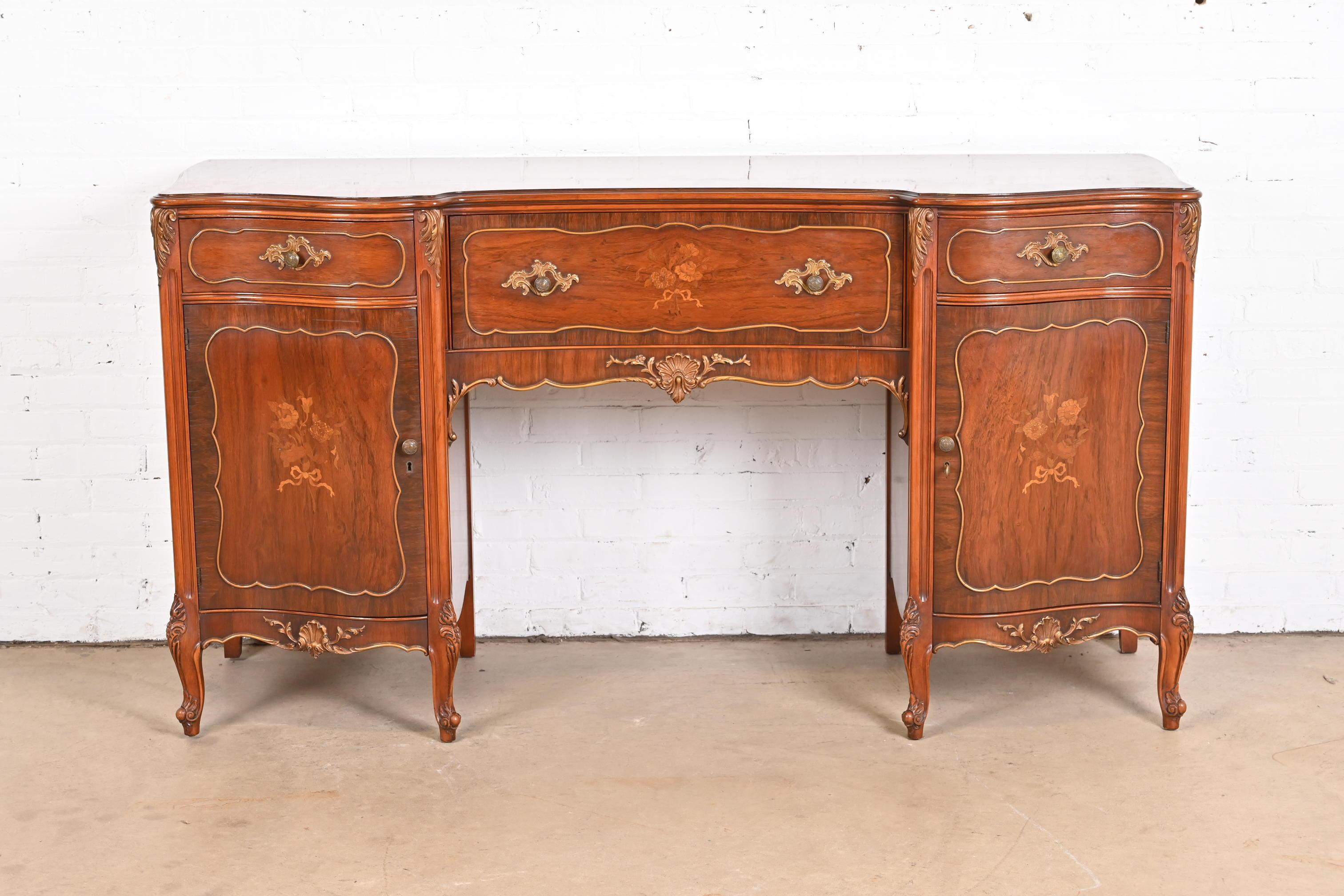 An exceptional French Provincial Louis XV style sideboard, credenza, or bar cabinet

By Romweber

USA, Circa 1920s

Gorgeous carved rosewood, with inlaid satinwood floral marquetry, and original brass hardware.

Measures: 70.5