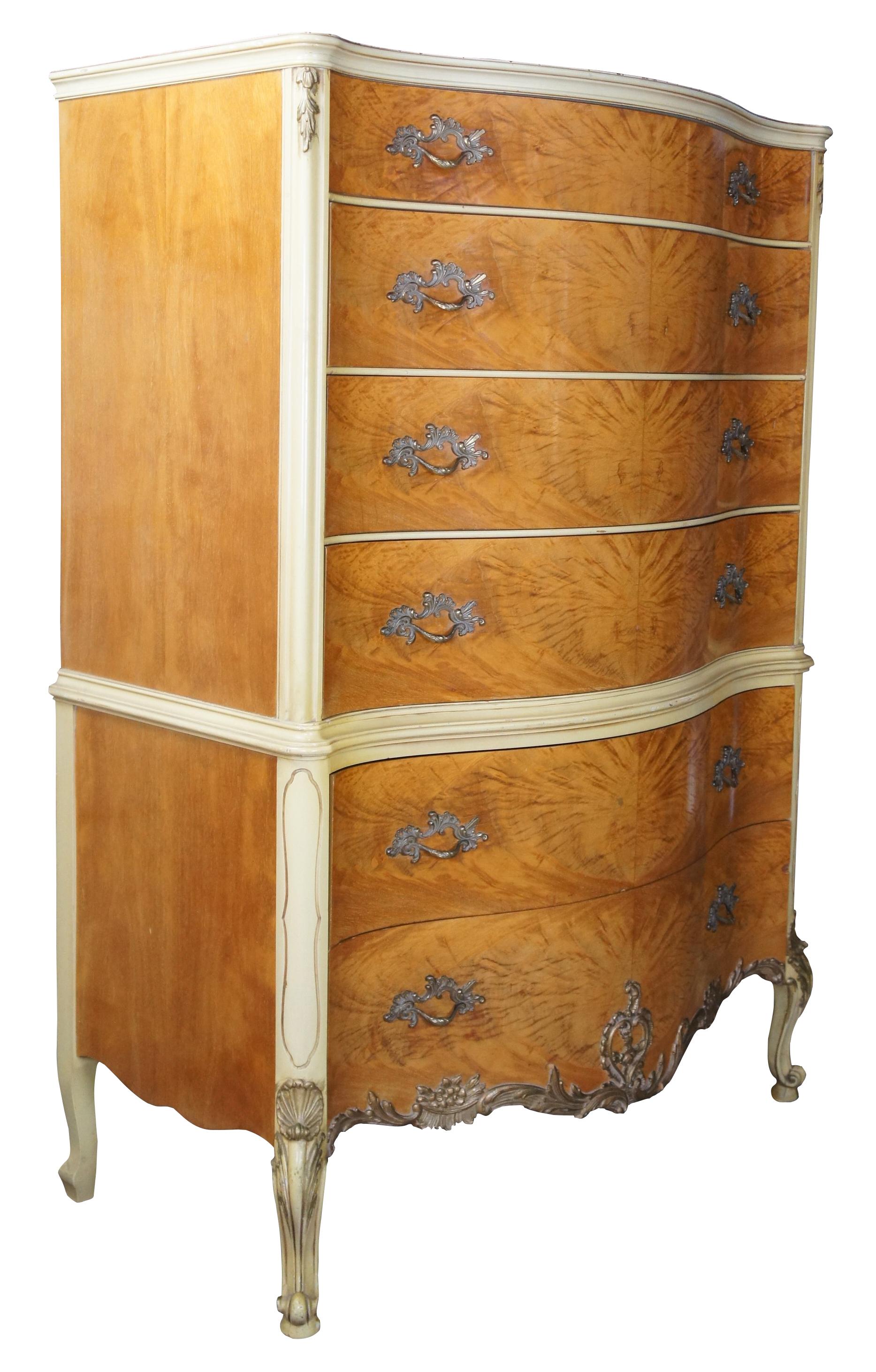 Impressive French inspired tallboy dresser by Romweber Furniture, circa 1950s. Features a serpentine or oxbow form with six dovetailed drawers and brass hardware. Drawers and top are made from an exotic African burled avodire wood. The rest of the