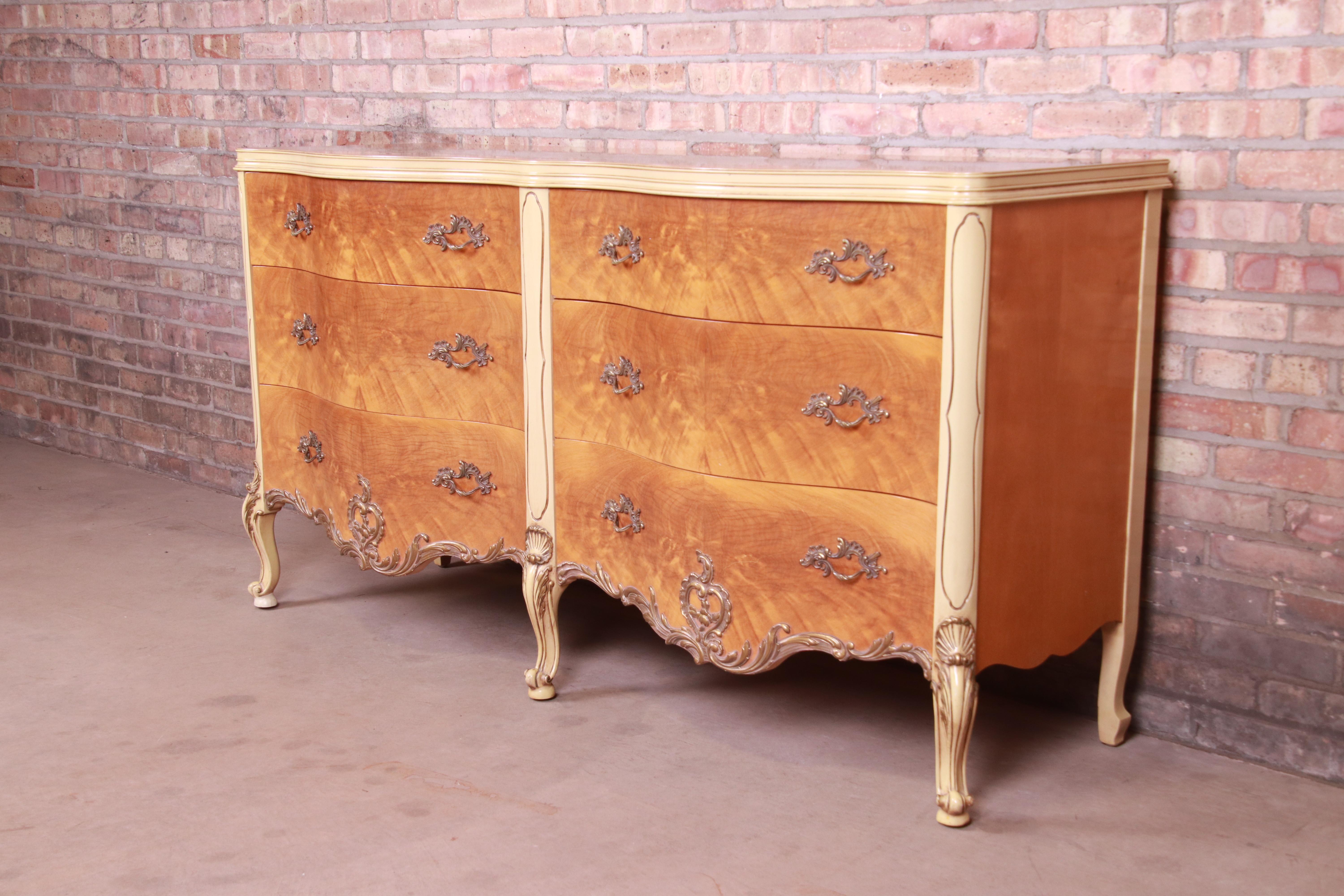 A gorgeous French Rococo Louis XV style double dresser or credenza

By Romweber

USA, Circa 1930s

Exotic burled African avodire wood, with paint and gilt details and original brass hardware.

Measures: 65