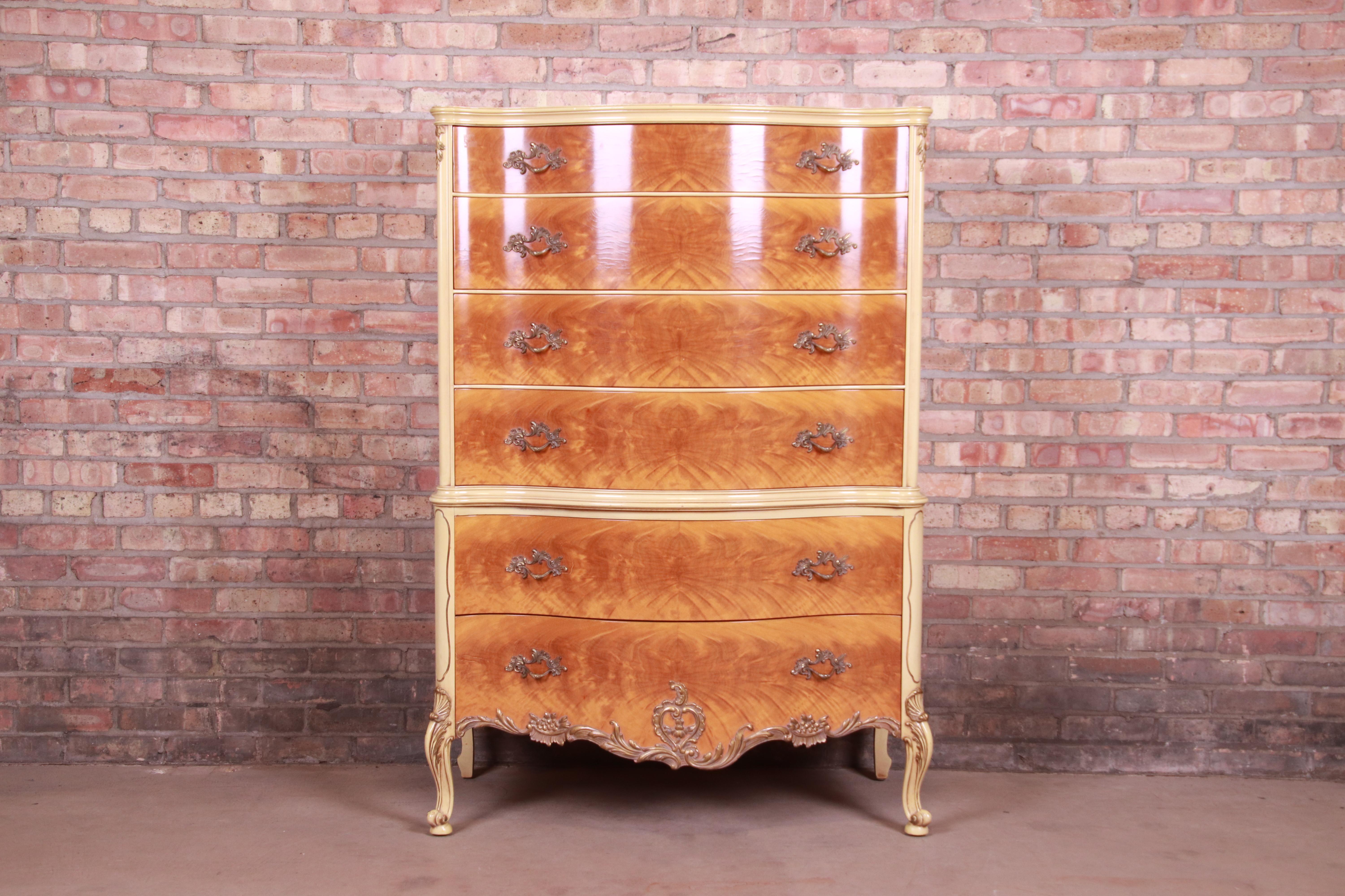A gorgeous French Rococo Louis XV style six-drawer highboy dresser

By Romweber

USA, circa 1930s

Exotic burled African avodire wood, with paint and gilt details and original brass hardware.

Measures: 38