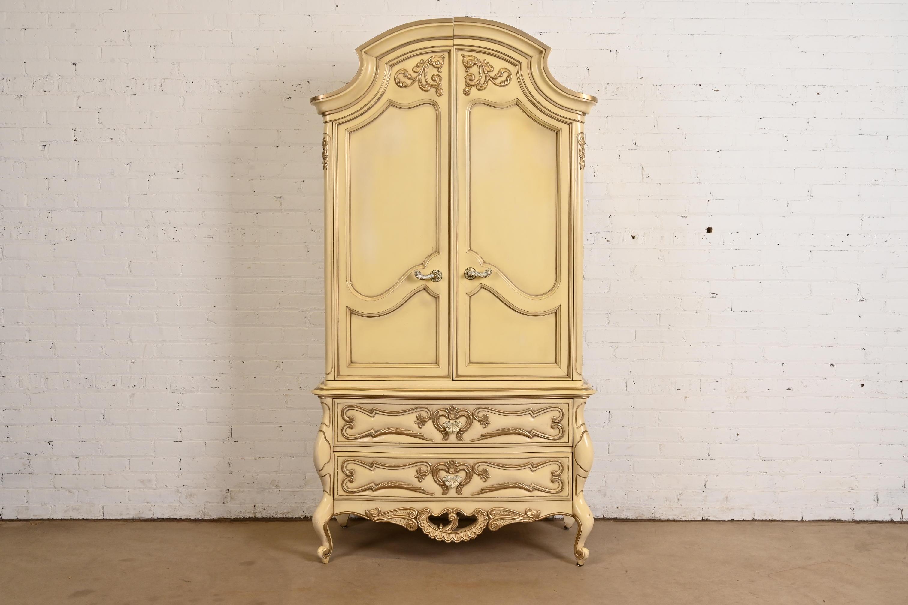 A gorgeous French Provincial or French Rococo Louis XV style armoire dresser

By Romweber

USA, Circa 1960s

Carved cream lacquered walnut, with silver gilt trim, and original brass hardware.

Measures: 40.5