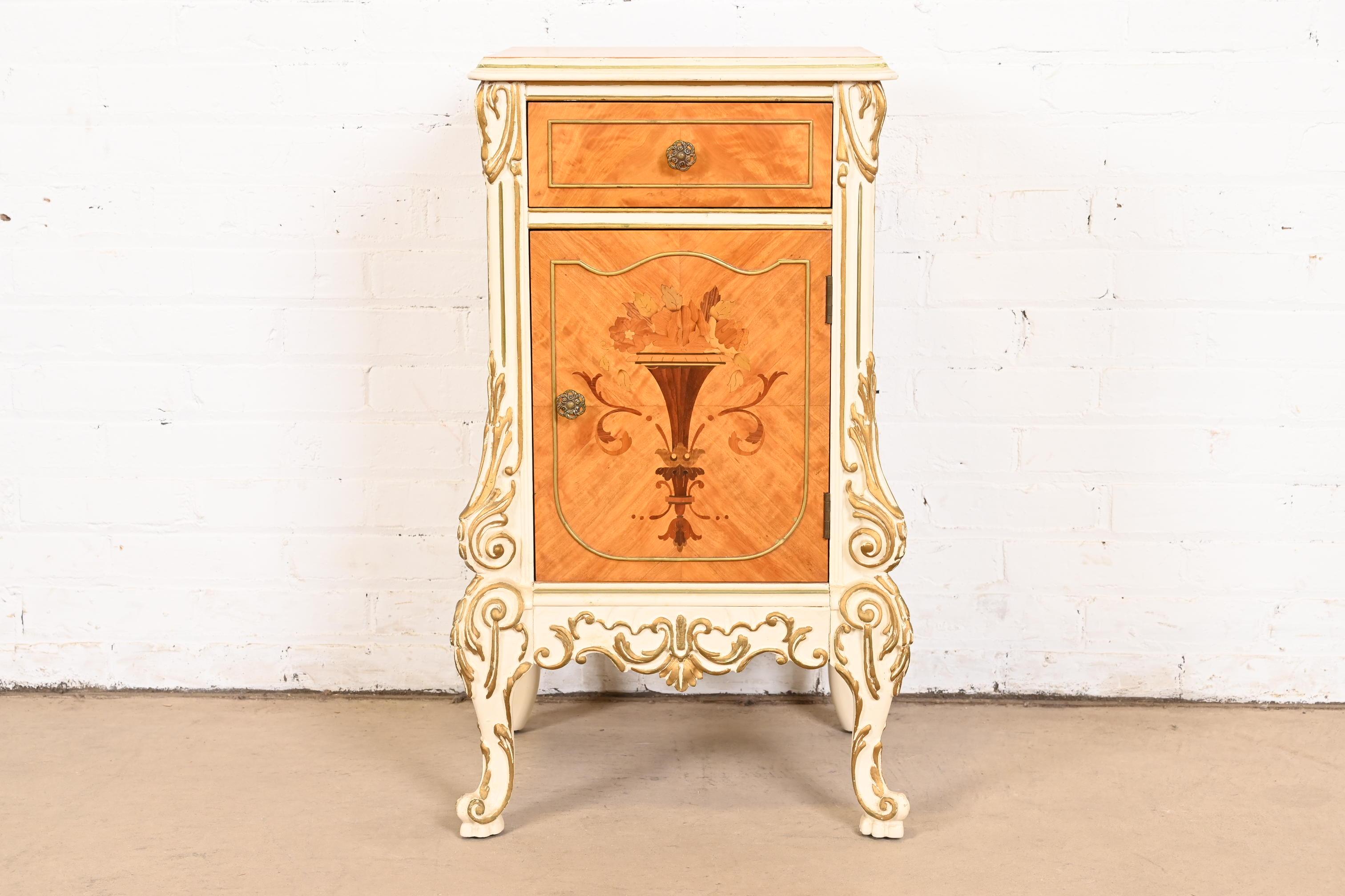 A gorgeous French Rococo Louis XV style nightstand

By Romweber

USA, Circa 1930s

Beautiful satinwood, with inlaid marquetry, painted and gilt details, and original brass hardware.

Measures: 17.75