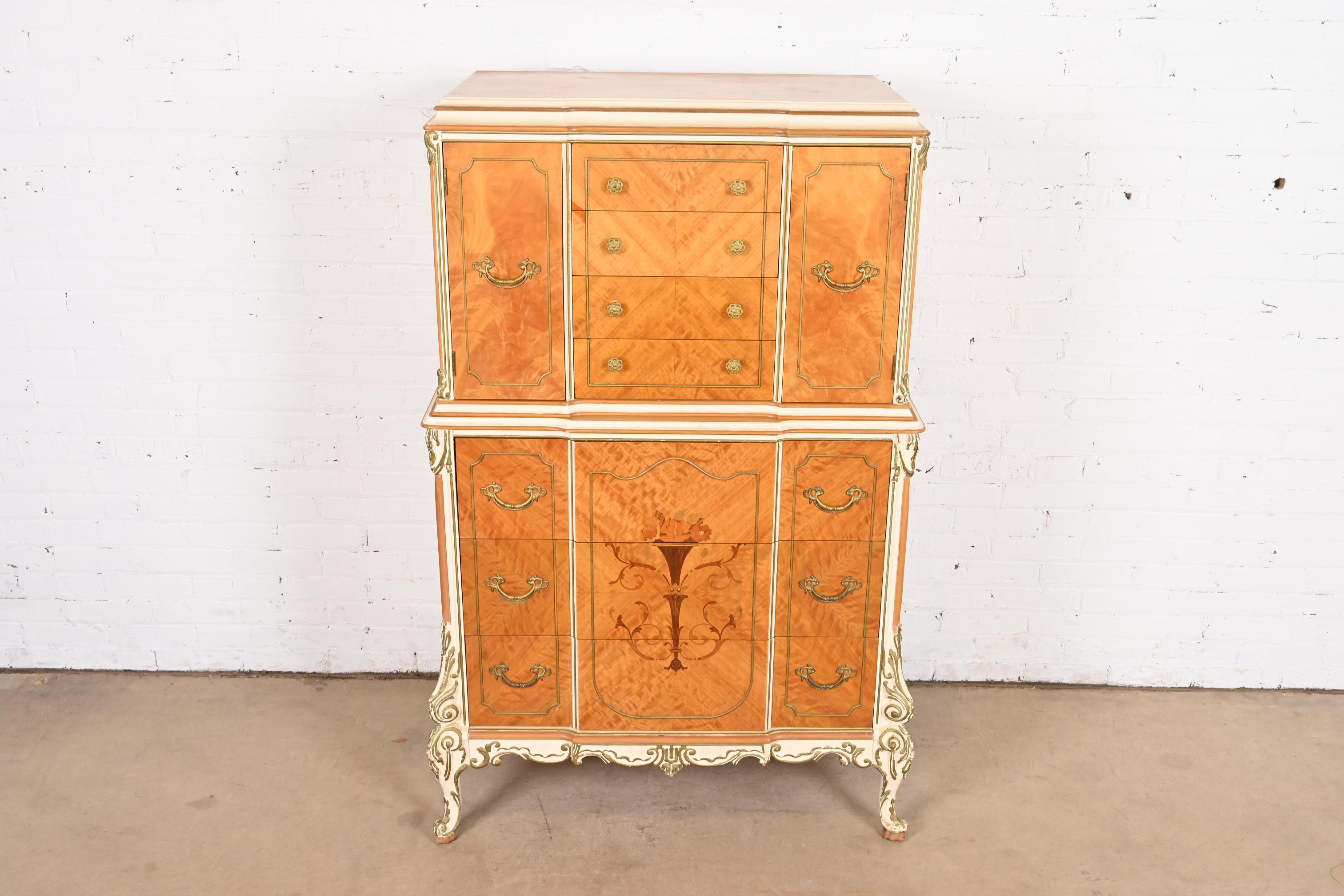 A gorgeous French Rococo Louis XV style highboy dresser

By Romweber

USA, Circa 1930s

Beautiful satinwood, with inlaid marquetry, painted and gold gilt details, and original brass hardware.

Measures: 36.25