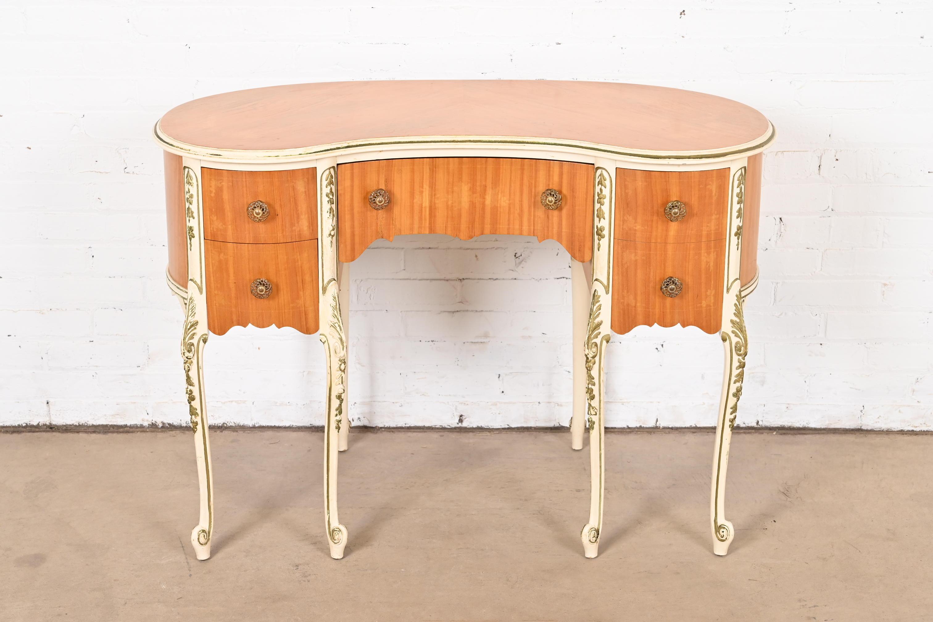 A gorgeous French Rococo Louis XV style vanity or writing desk

By Romweber

USA, Circa 1930s

Beautiful satinwood, with painted and gold gilt details, and original brass hardware.

Measures: 43