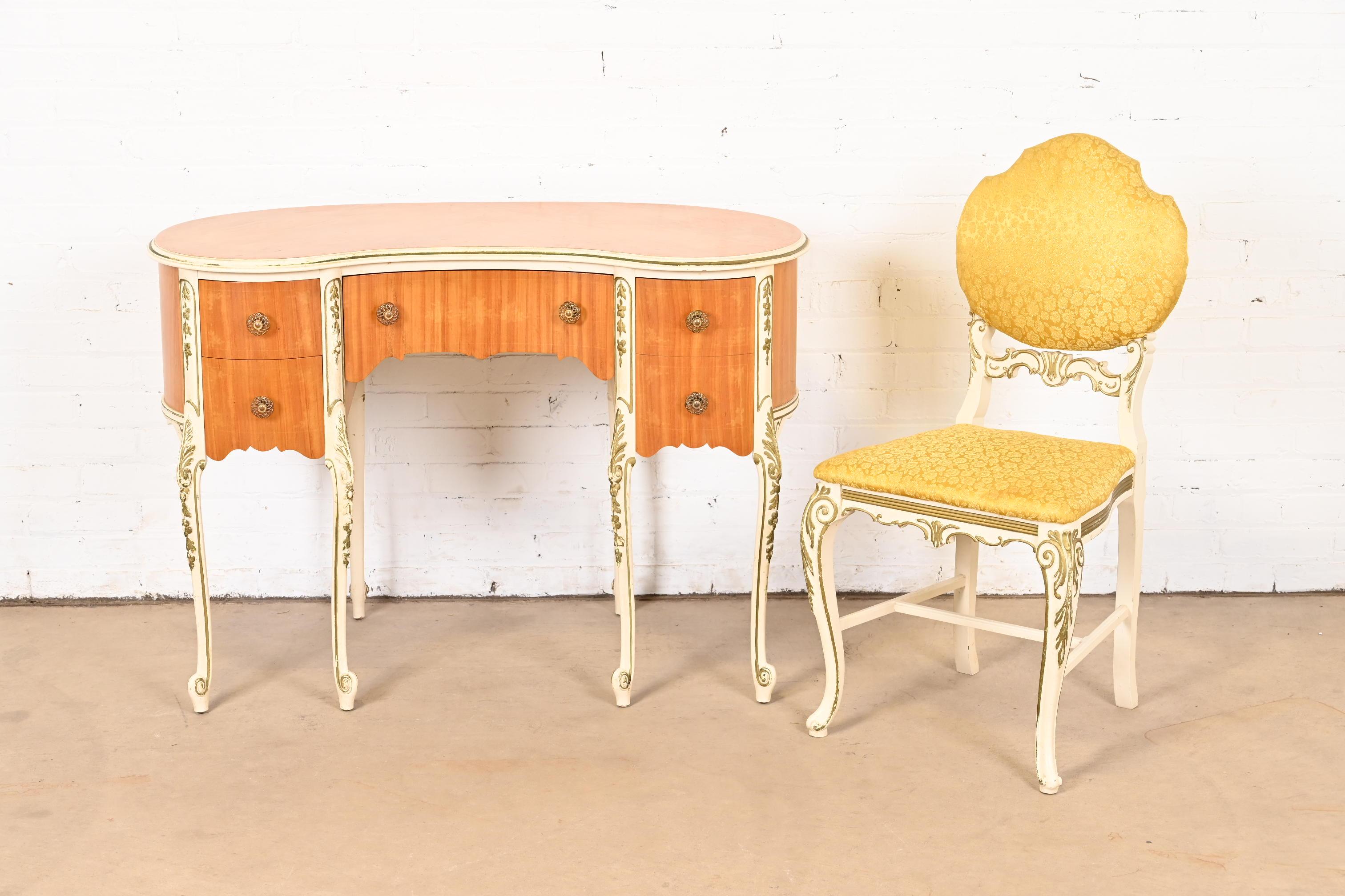 A gorgeous French Rococo Louis XV style vanity or writing desk with matching chair

By Romweber

USA, Circa 1930s

Beautiful satinwood, with painted and gold gilt details, and original brass hardware. Chair is upholstered in a yellow floral