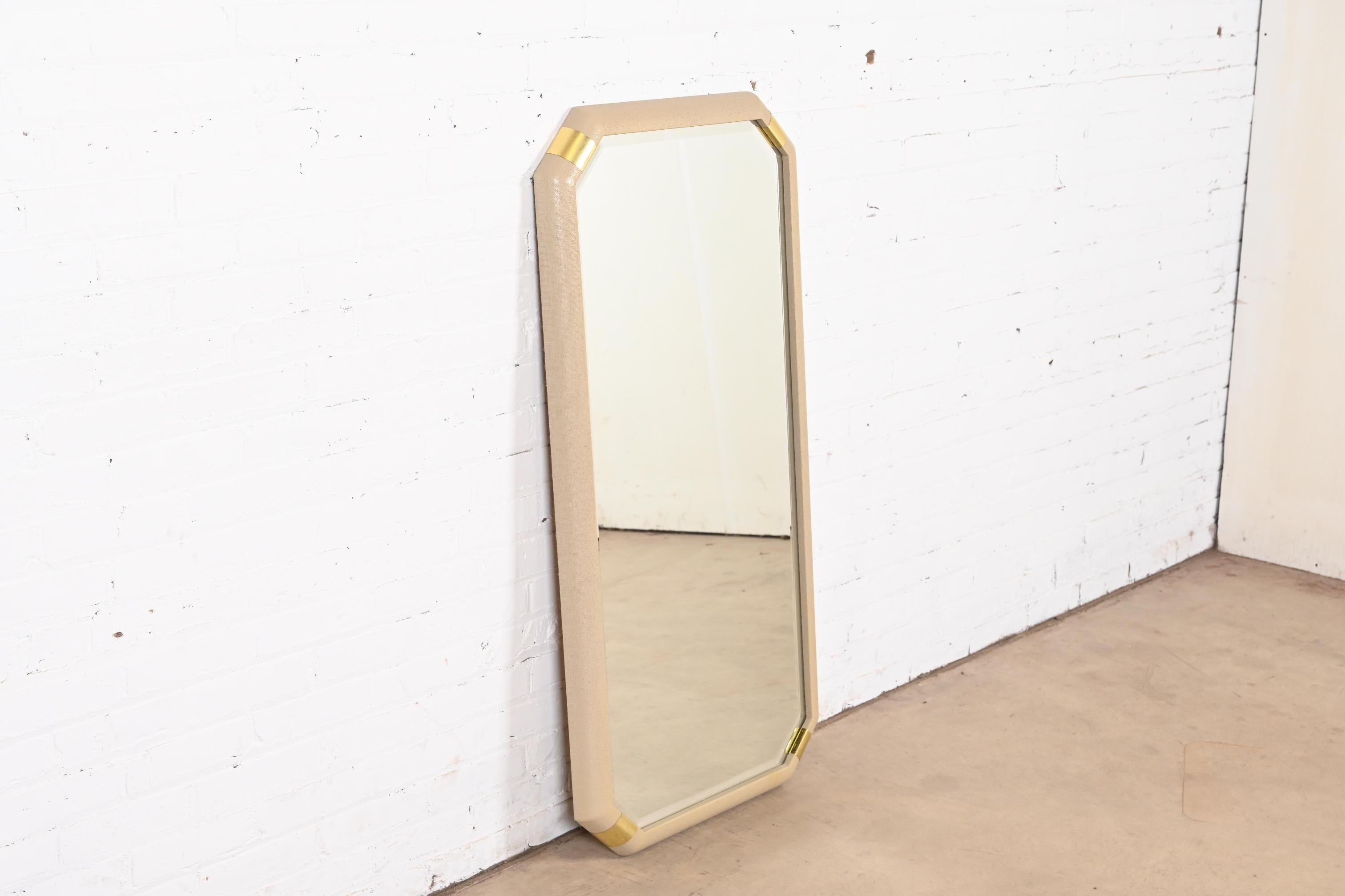 An exceptional Modern Hollywood Regency Chinoiserie wall mirror

By Romweber

USA, Circa 1980s

Beveled glass mirror, with beautiful lacquered grasscloth and brass frame.

Measures: 23.38
