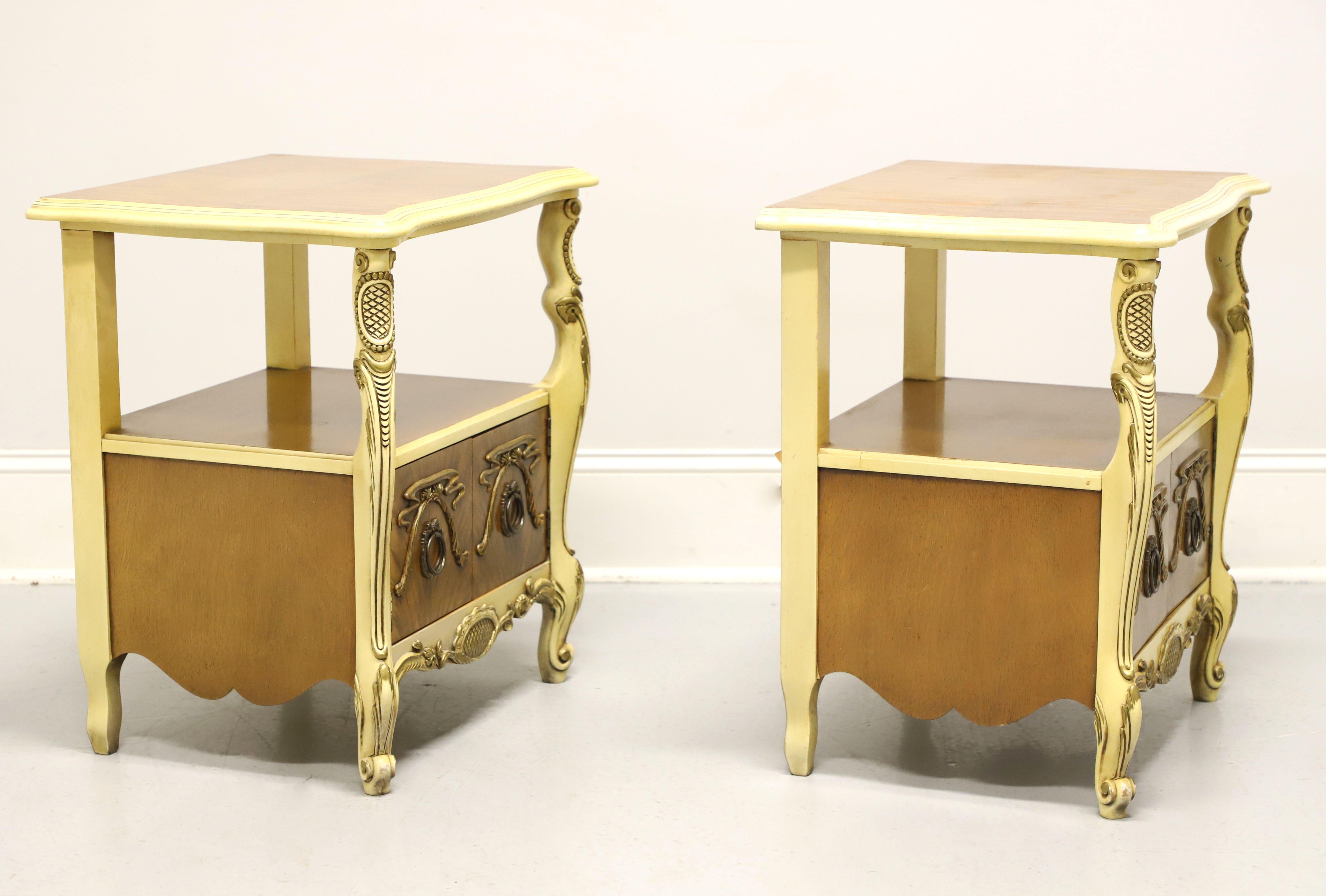 A pair of French Provincial style nightstands by Romweber Furniture, from their Marquise Collection. Solid wood painted an antique white with satinwood to the top, door fronts & sides, ogee edge to the top, serpentine front, brass hardware, carved