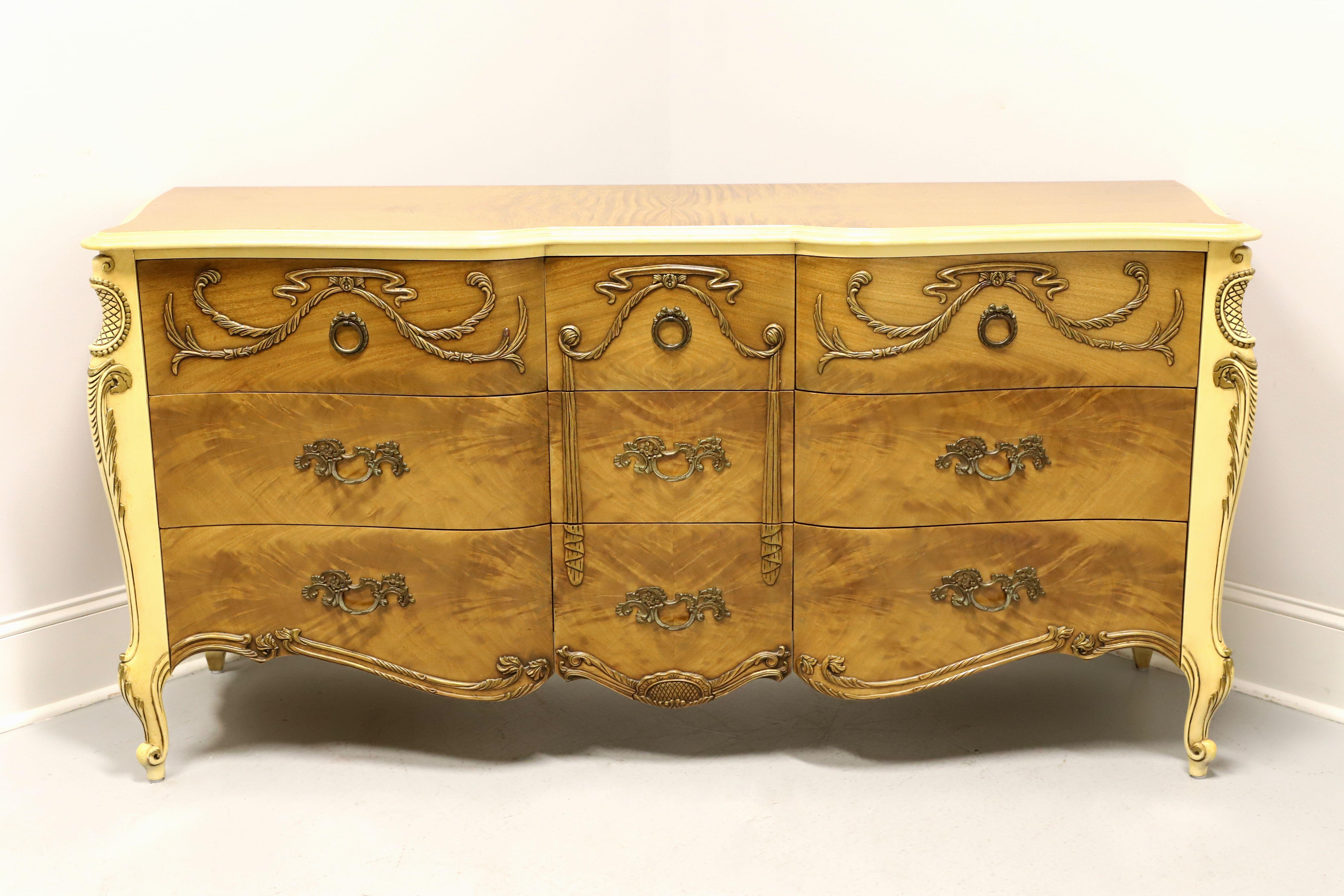 A French Provincial style triple dresser by Romweber Furniture, from their Marquise Collection. Solid wood painted an antique white with satinwood to the top, drawer fronts & sides, ogee edge to the top, serpentine front, brass hardware, carved