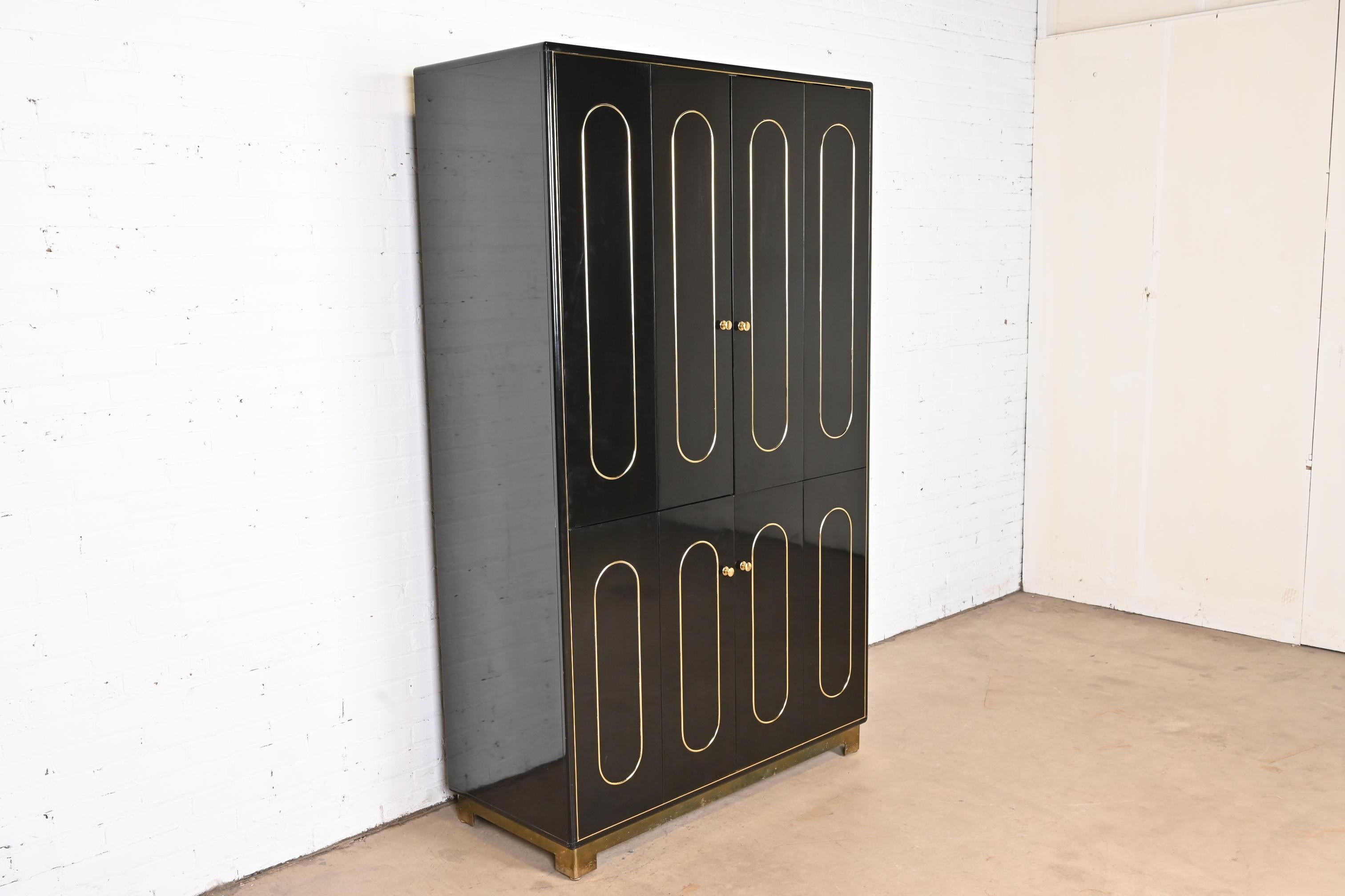 A gorgeous Mid-Century Modern lighted bar cabinet

By Romweber

USA, circa 1970s

Black lacquered wood, with brass hardware. Interior with mirrored back, glass shelves, and pull-out tray for mixing drinks.

Measures: 48