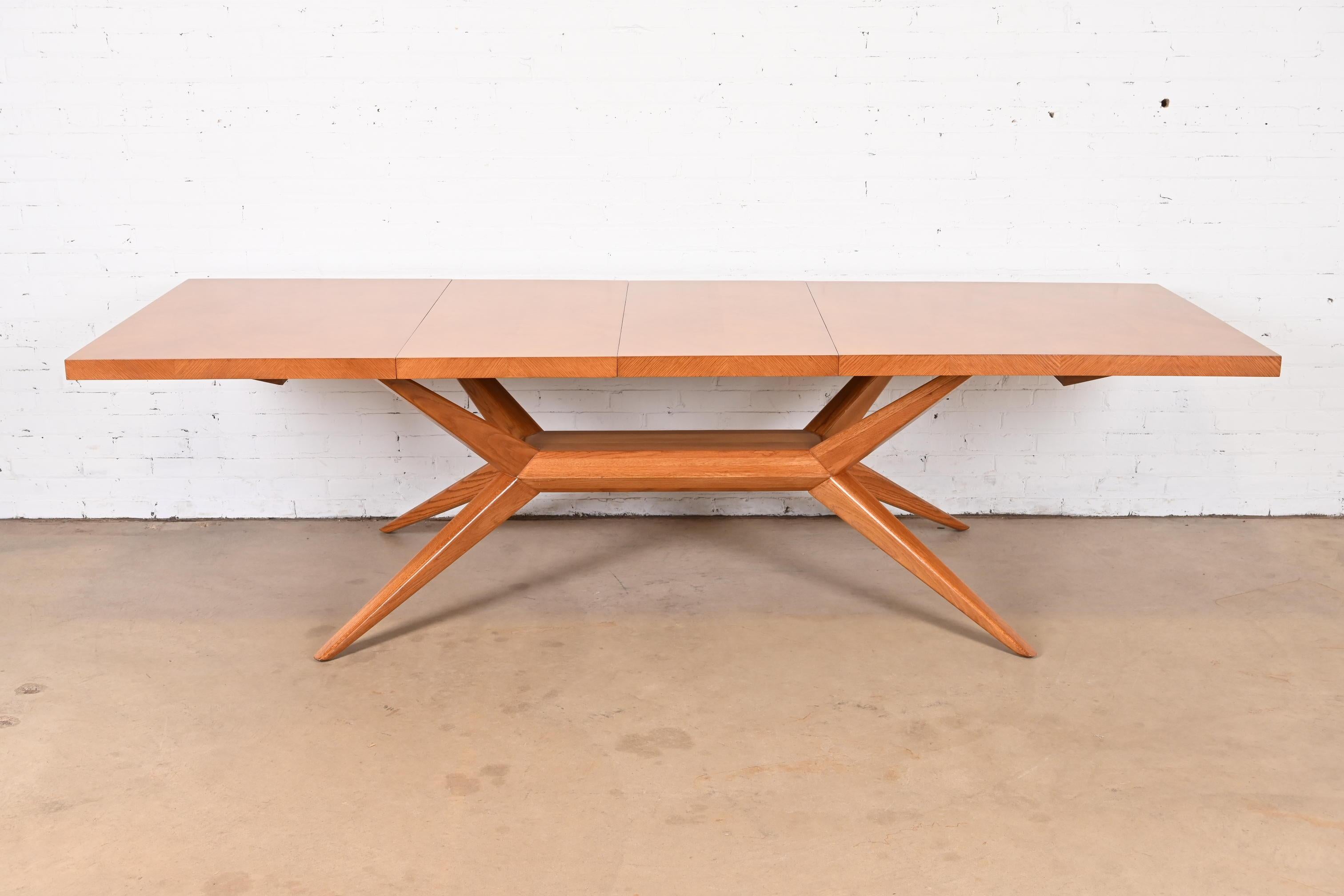An outstanding Mid-Century Modern extension dining table

By Harold Schwartz for Romweber

USA, 1950s

Sculpted oak with parquetry top, splayed spider legs, and unique felt-lined cutlery drawers on each end.

Measures: 69.75