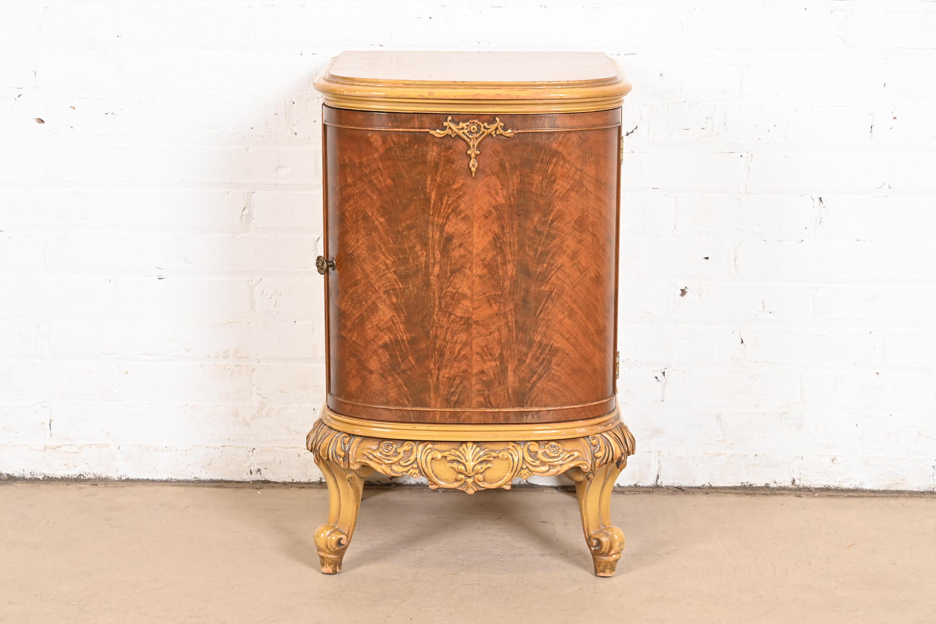 A gorgeous French Provincial Louis XV style nightstand

In the manner of Romweber

USA, Circa 1920s

Beautiful flame mahogany, with painted trim and legs, and original brass hardware.

Measures: 17.25