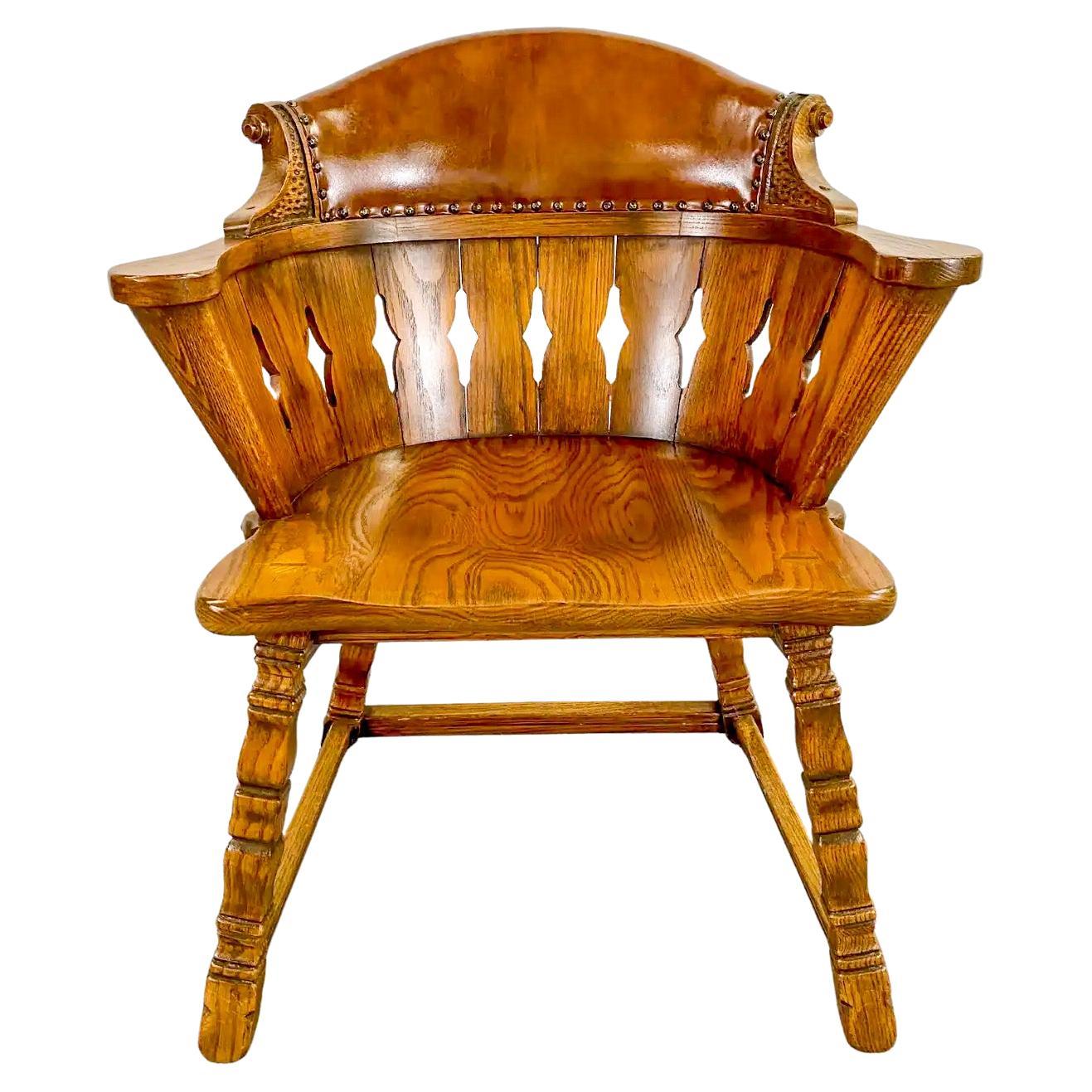 A rare set of 4 Romweber Viking oak leather back captains dining or side armchairs in Jacobean style. The quality chairs are hand crafted of oak showing beautiful grain and feature fine craving details. The barrel shaped chairs are sturdy and