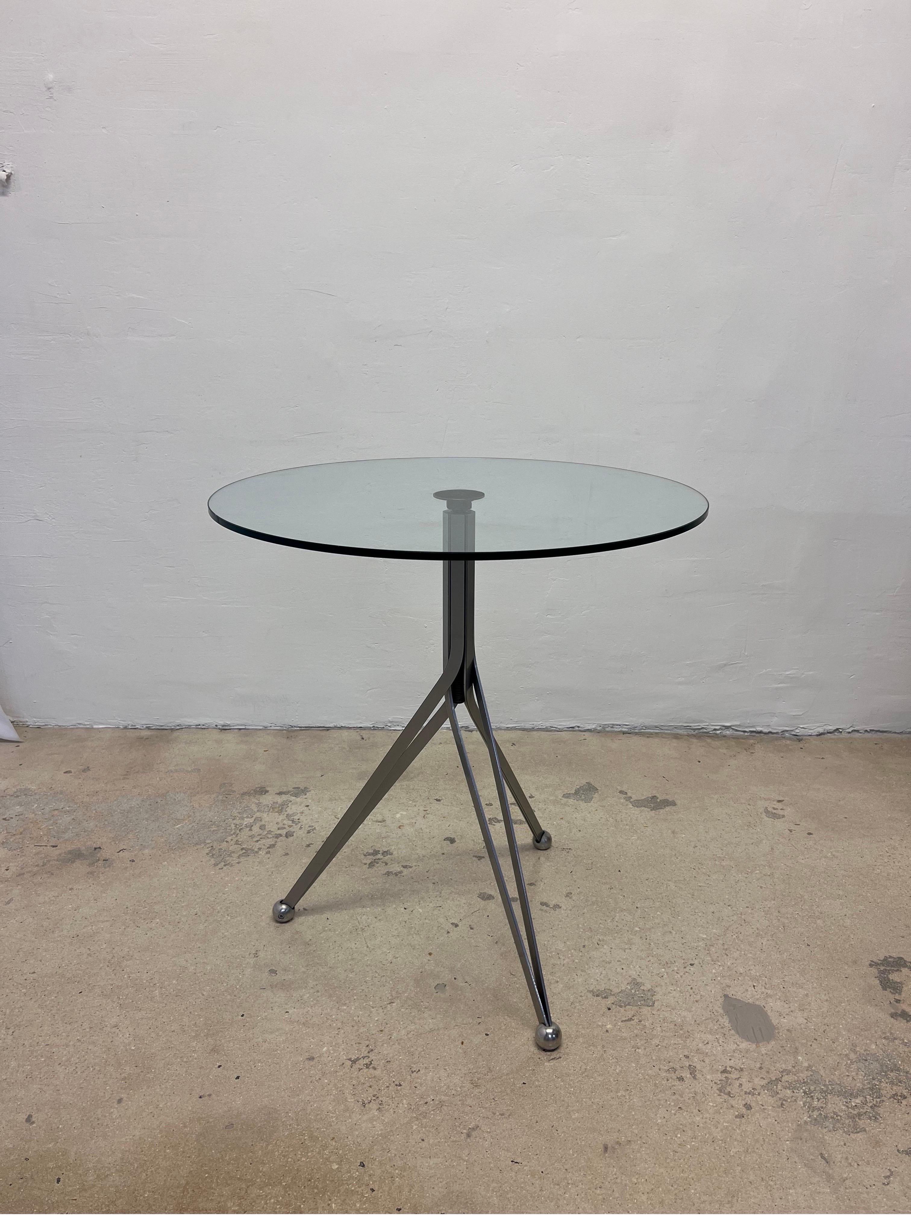 Contemporary adjustable height bistro table with gray steel base and round glass top designed by Ron Arad in 1994 for Zeus.  Table top is adjustable between 29.5