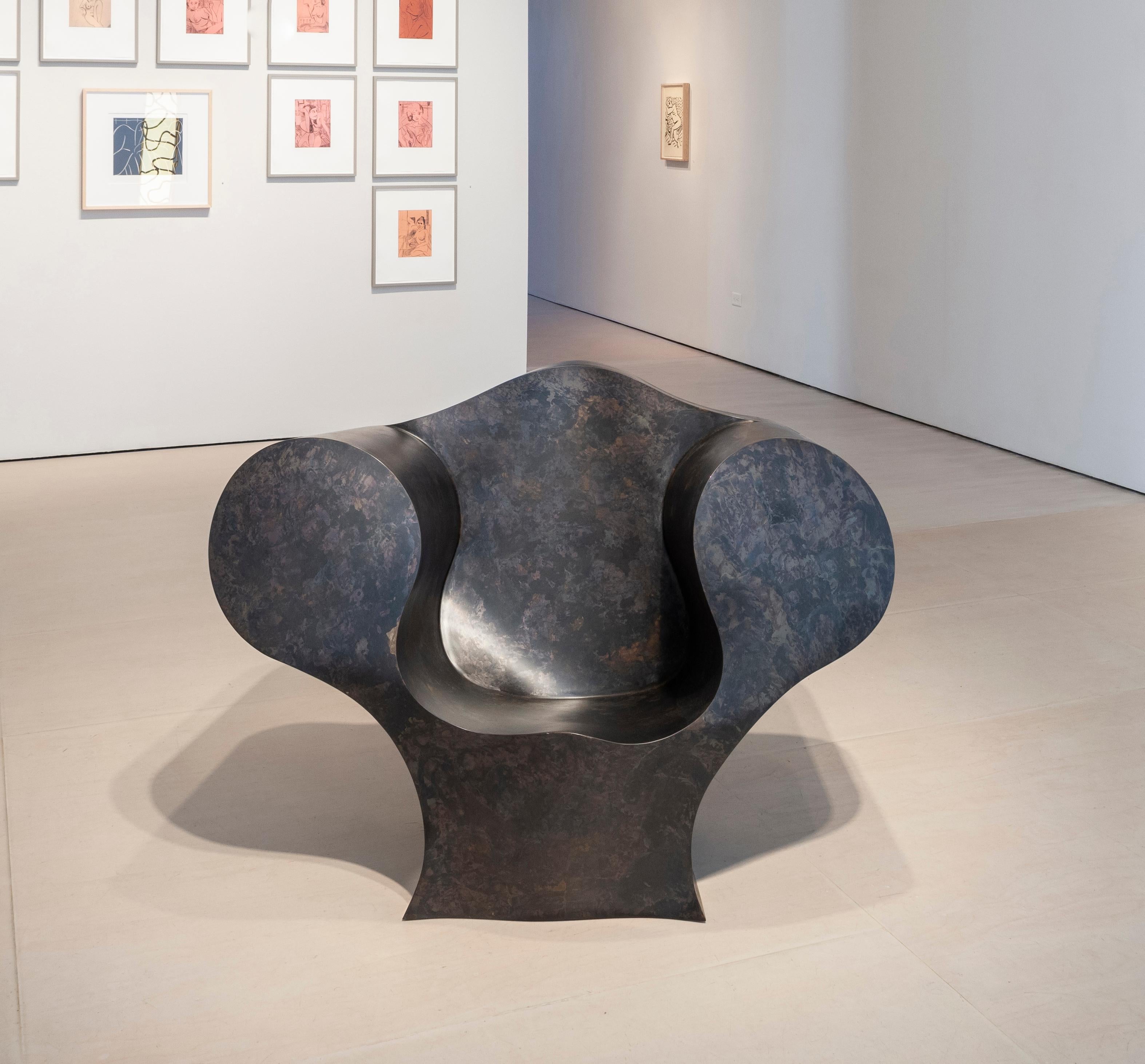 This steel chair by architect and furniture designer Ron Arad has the shape of a comfortable overstuffed chair but the cold steel presents a hard reality which makes it more sculpture than seating. This piece is number 4 out of five artist's proofs