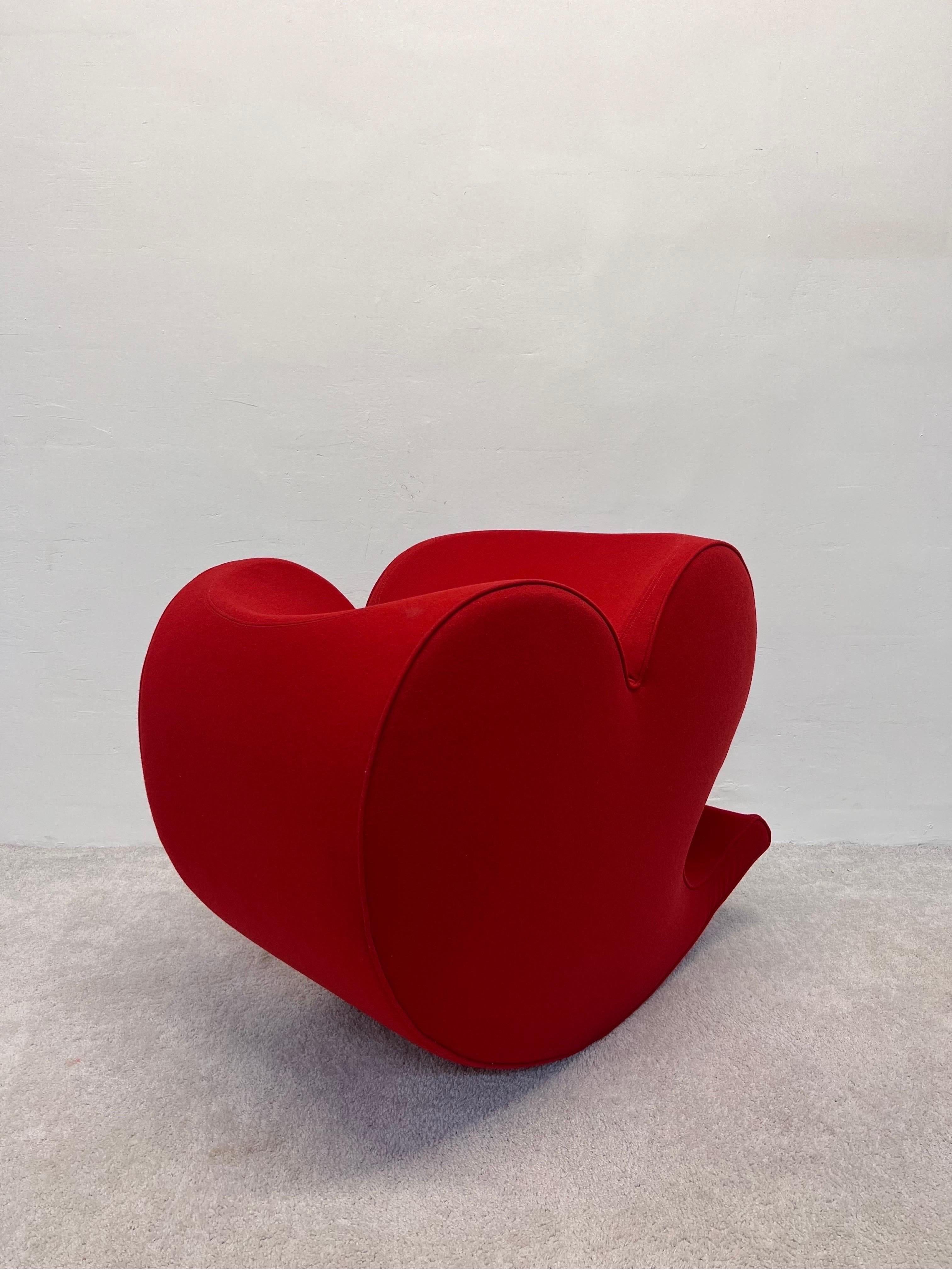 Spring Collection Soft Heart chair designed by Ron Arad in 1988 for Moroso. This example is from the early 1990s. The base of the chair is weighted with a heavy steel plate for counterbalance. The original red wool fabric is in great condition and