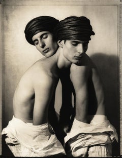 Twins Entwined, 1991: Identical twins photographed together in studio portrait.