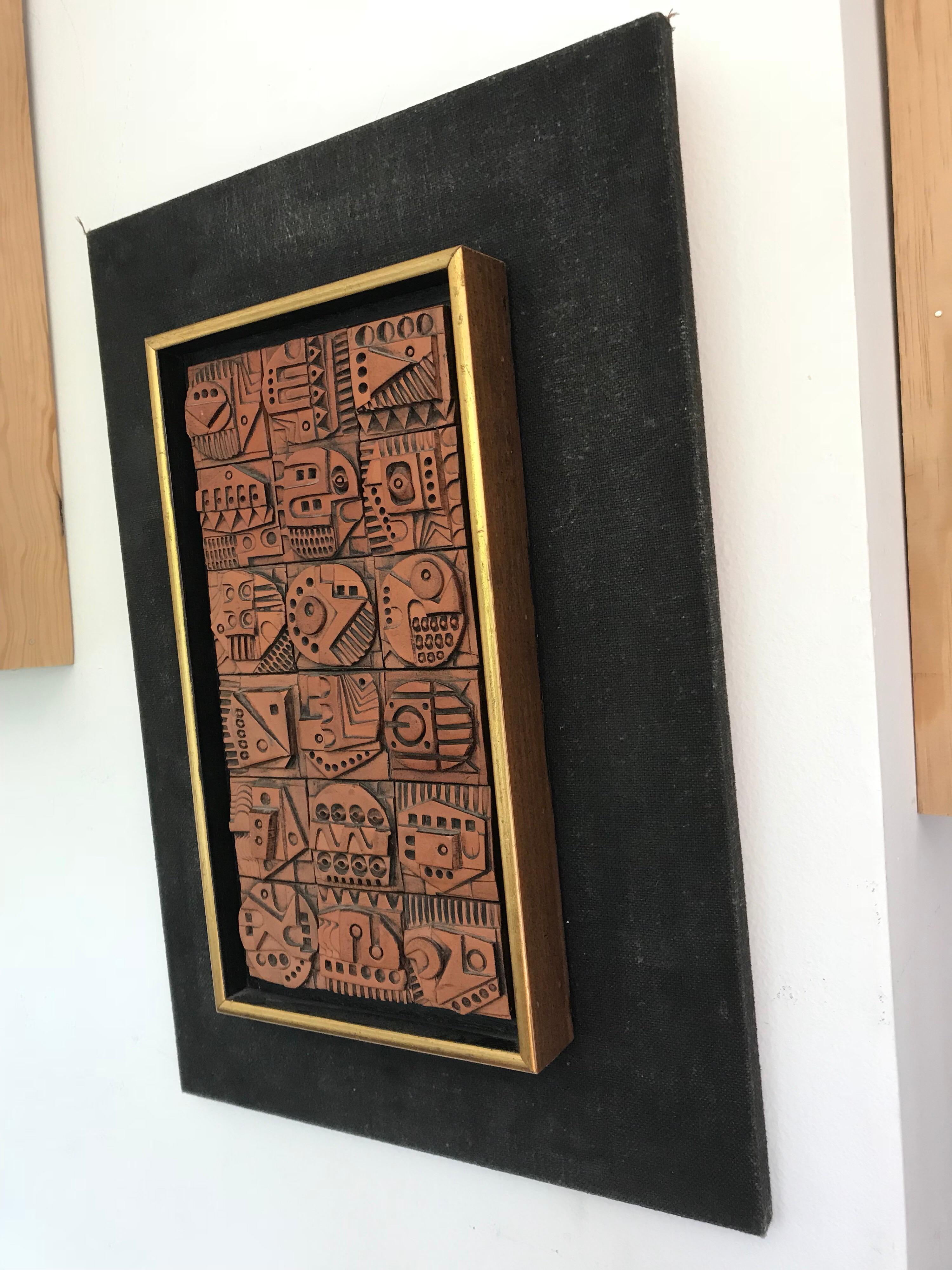 A nice decorative piece of modern art.
Made of ceramic on wood with linen and wood frame.
It's in the original condition with a small chip, barely visible, on one of the glyphs (please see pic).
 