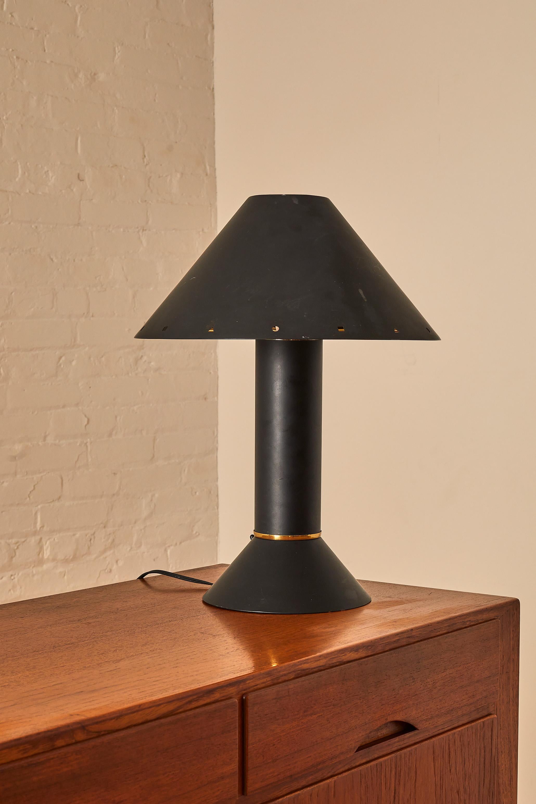 Postmodern Ron Rezek California copper table lamp. Classic form and motif of the era in Black metal. White enamel reflector shade attaches to base, outer copper shade rests on top.