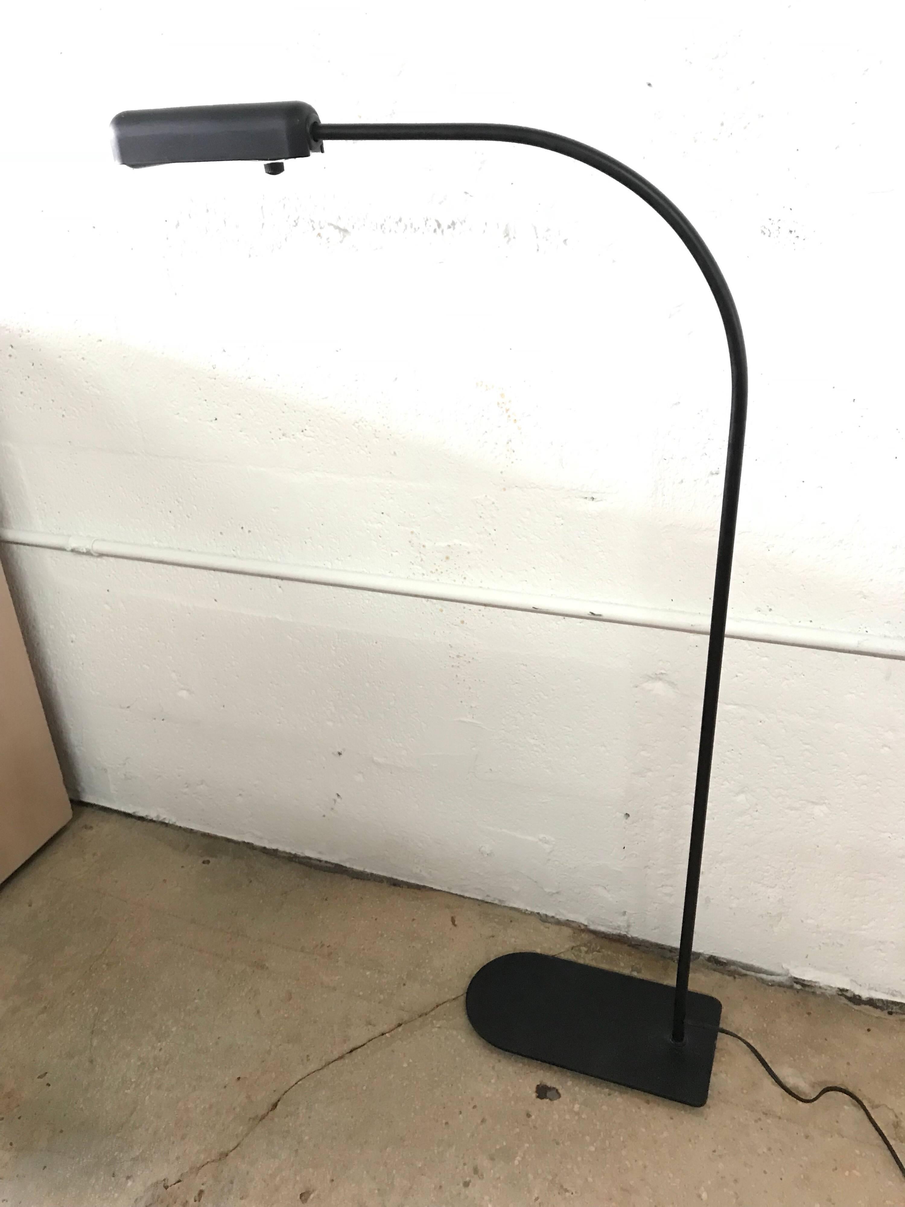 Black postmodern floor lamp designed by Ron Rezek, perfect as a reading lamp, next to a chair, sofa, or chaise.