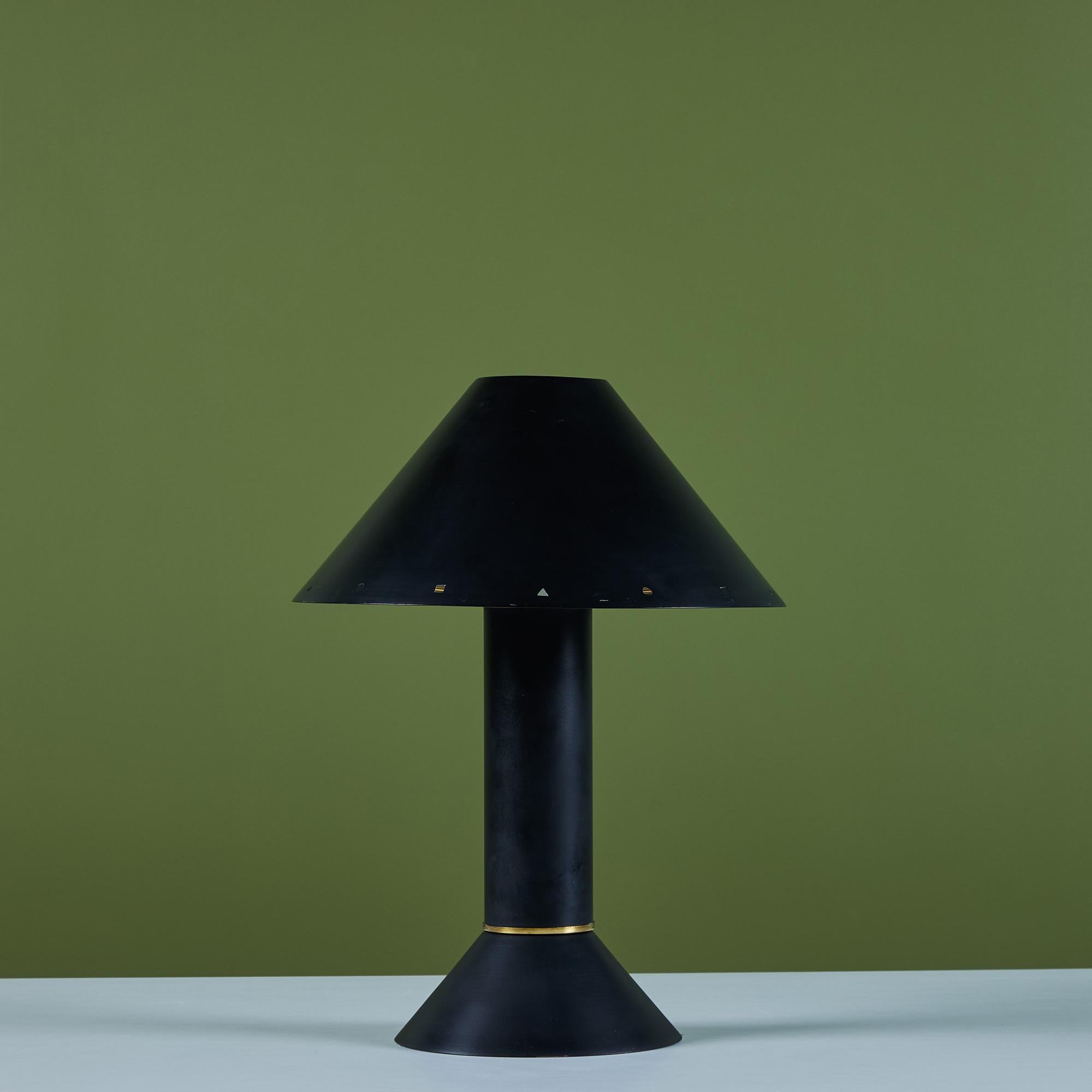 Postmodern table lamp by Los Angeles lighting designer Ron Rezek, c.1980s. The lamp features a black enameled metal frame and removable black shade with polished brass ring accent that sits at the bottom of cone shaped base. The shade features