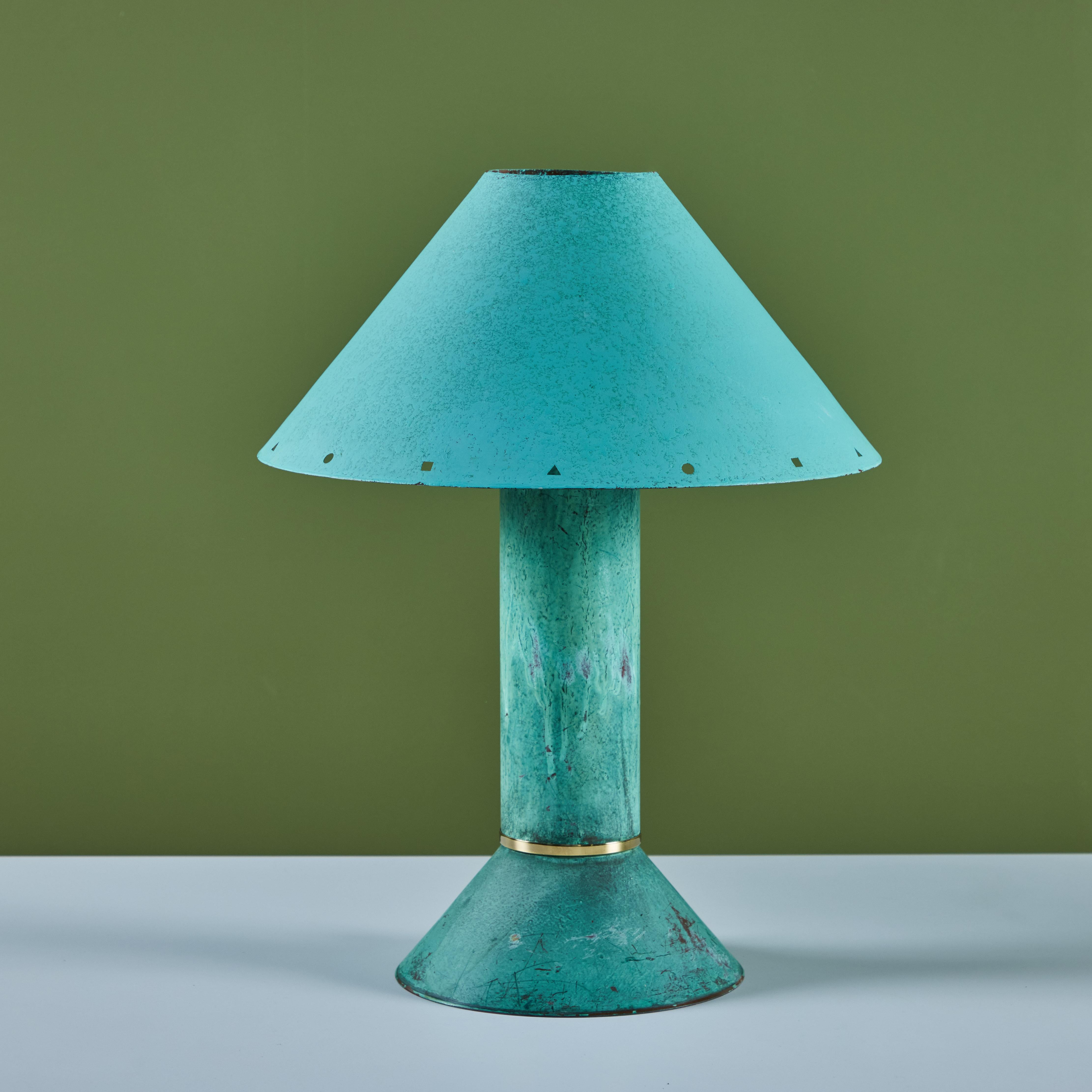 Postmodern table lamp by Los Angeles lighting designer Ron Rezek, c.1980s. The lamp features a verdigris metal frame and removable shade with polished brass ring accent that sits at the bottom of cone shaped base. The shade features different shaped