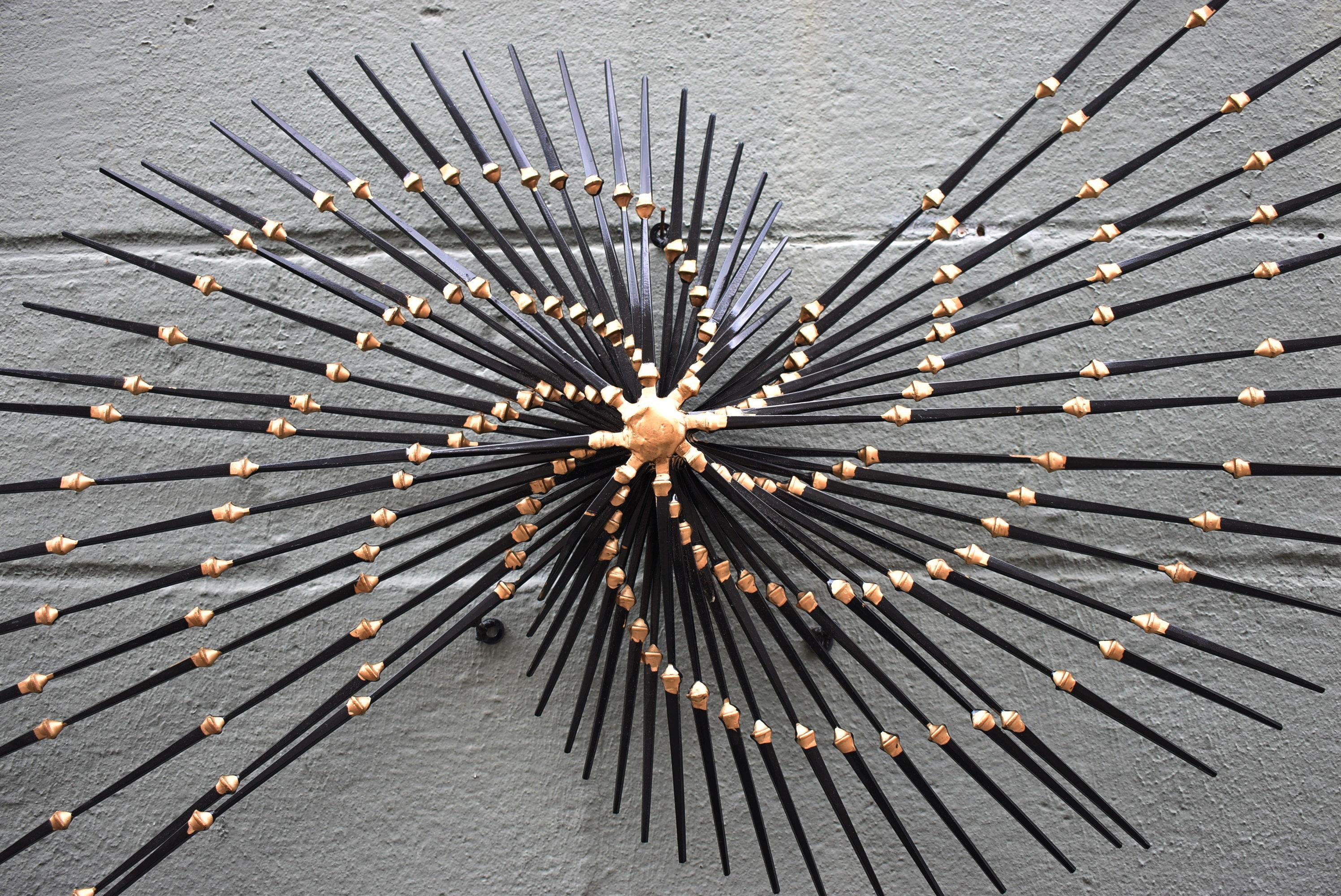 Mid-Century Modern iron, brass and nail Brutalist wall sculpture by Ron Schmidt circa 1960's. Fan pinwheel pattern. Very nice condition. Dimensions: 3.5