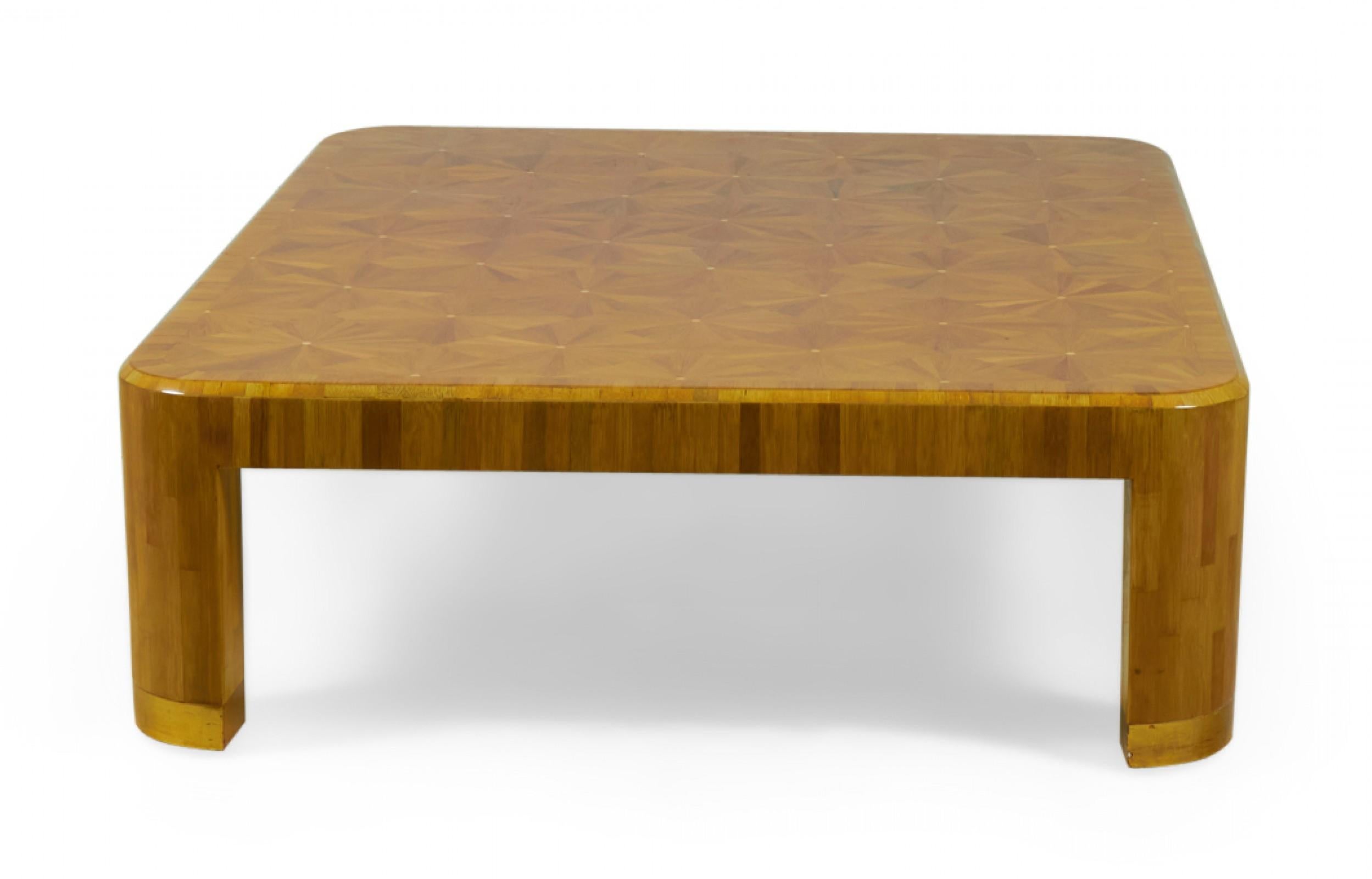 American high style (circa 1980s) rectangular coffee table with a straw (raffia wood) veneer marquetry top in a starburst pattern having a high gloss lacquer finish, resting on curved straw veneer legs ending in gilt trim. (RON SEFF)
 