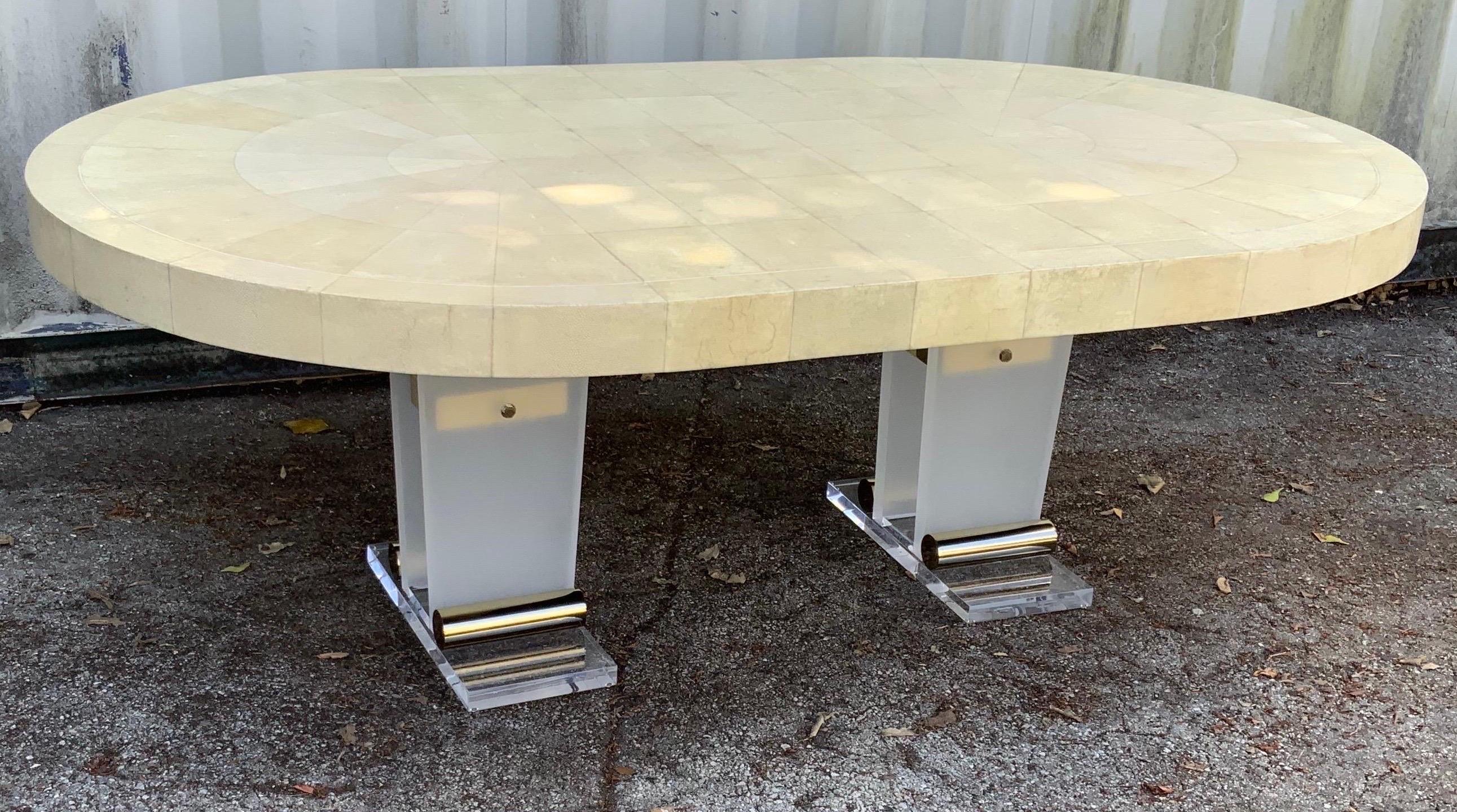 Beautiful Ron Seff Art Deco Style dining room table, can also be used as a desk.
Shagreen top and lucite legs with brass accent.