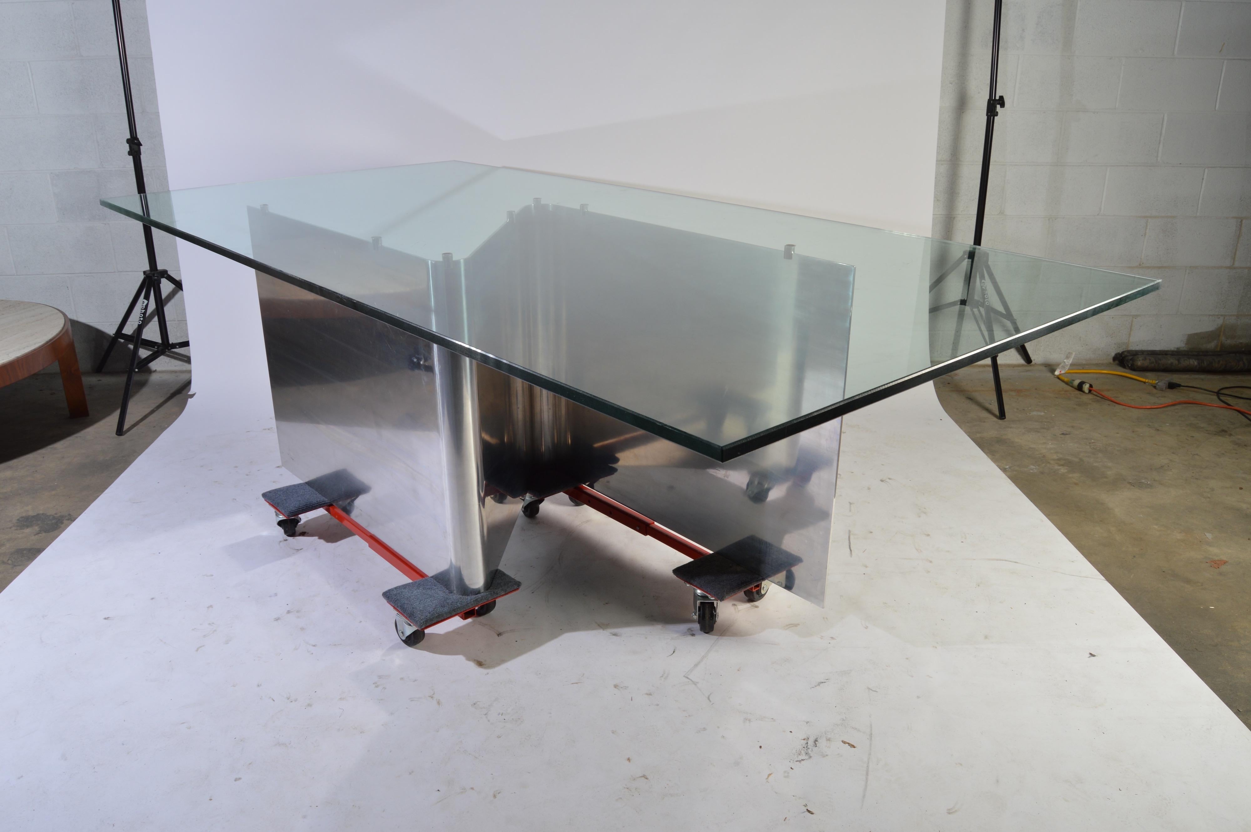 A stunning sculptural steel dining table with 1/2” thick glass top after master designer Ron Seff, circa 1970. Contemporary elegance at its best. 
Outstanding overall condition having one tiny edge chip to glass as pointed out in image provided.
