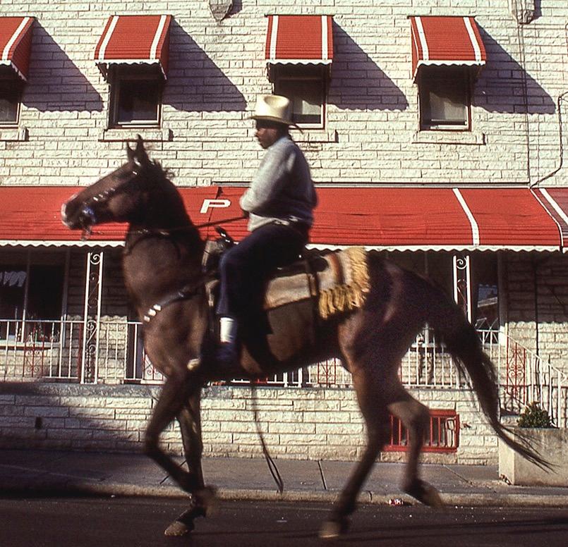 Ride By Rows: photo of Black urban cowboy in Philadelphia city - Photograph by Ron Tarver