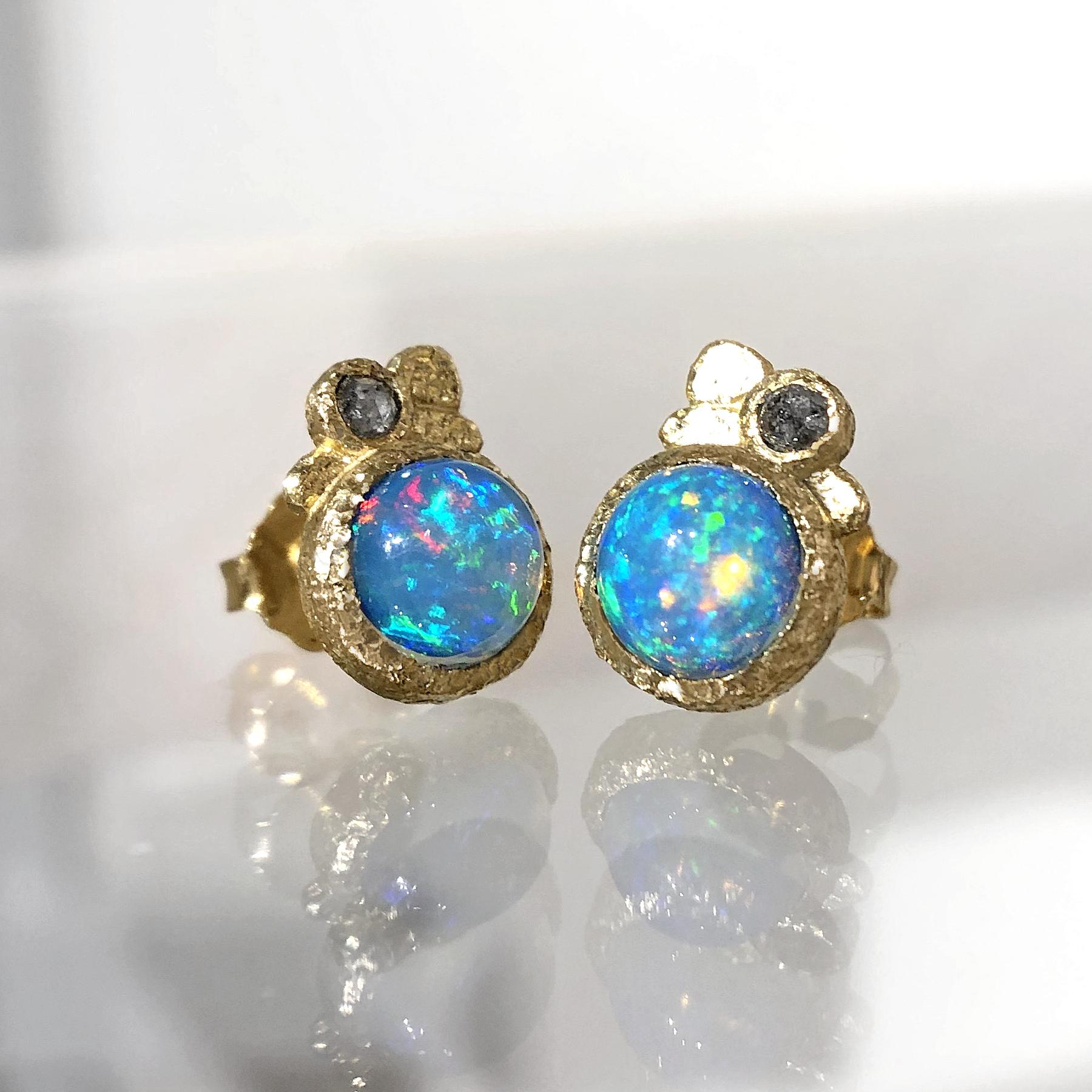 One of a Kind Earrings handcrafted by jewelry maker Rona Fisher featuring a matched pair of fiery deep blue Ethiopian opals with strong flashes of orange, red, and green, bezel-set in beautifully-textured 18k yellow gold and accented by a pair of