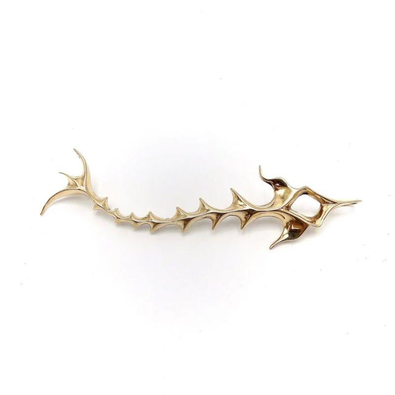 Ronald Hayes Pearson (1924 -96) was an influential figure in metalsmithing and modern jewelry. He regarded precious metals as plastic substances to be stretched or elongated into simple, elegant forms. This 14k gold fish pendant clearly reflects