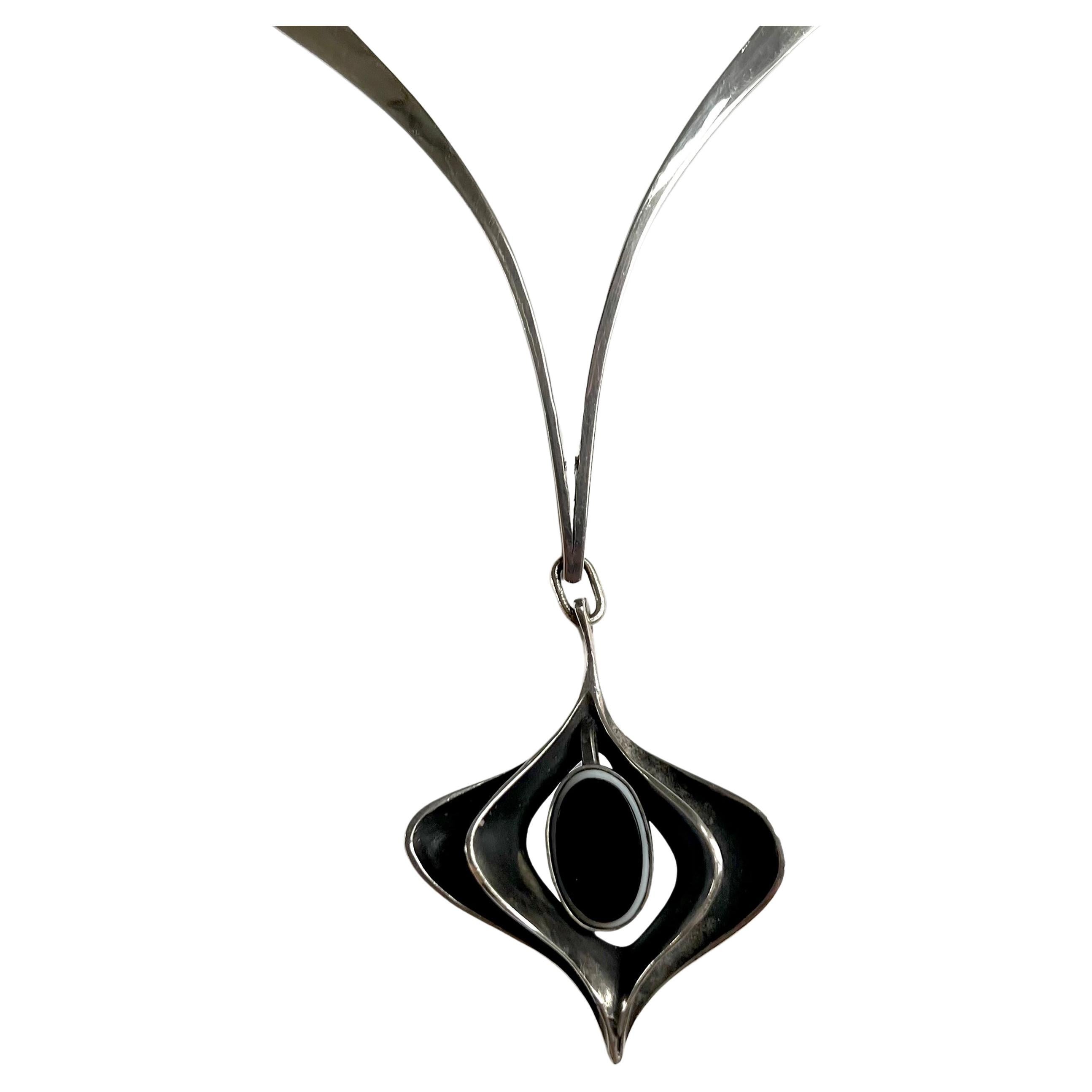 Sculptural pendant necklace with oval onyx stone at its center, created by Ronald Hayes Pearson  (1924-1996) of Rochester, New York.  Necklace has a wearable neck length of approximately 17