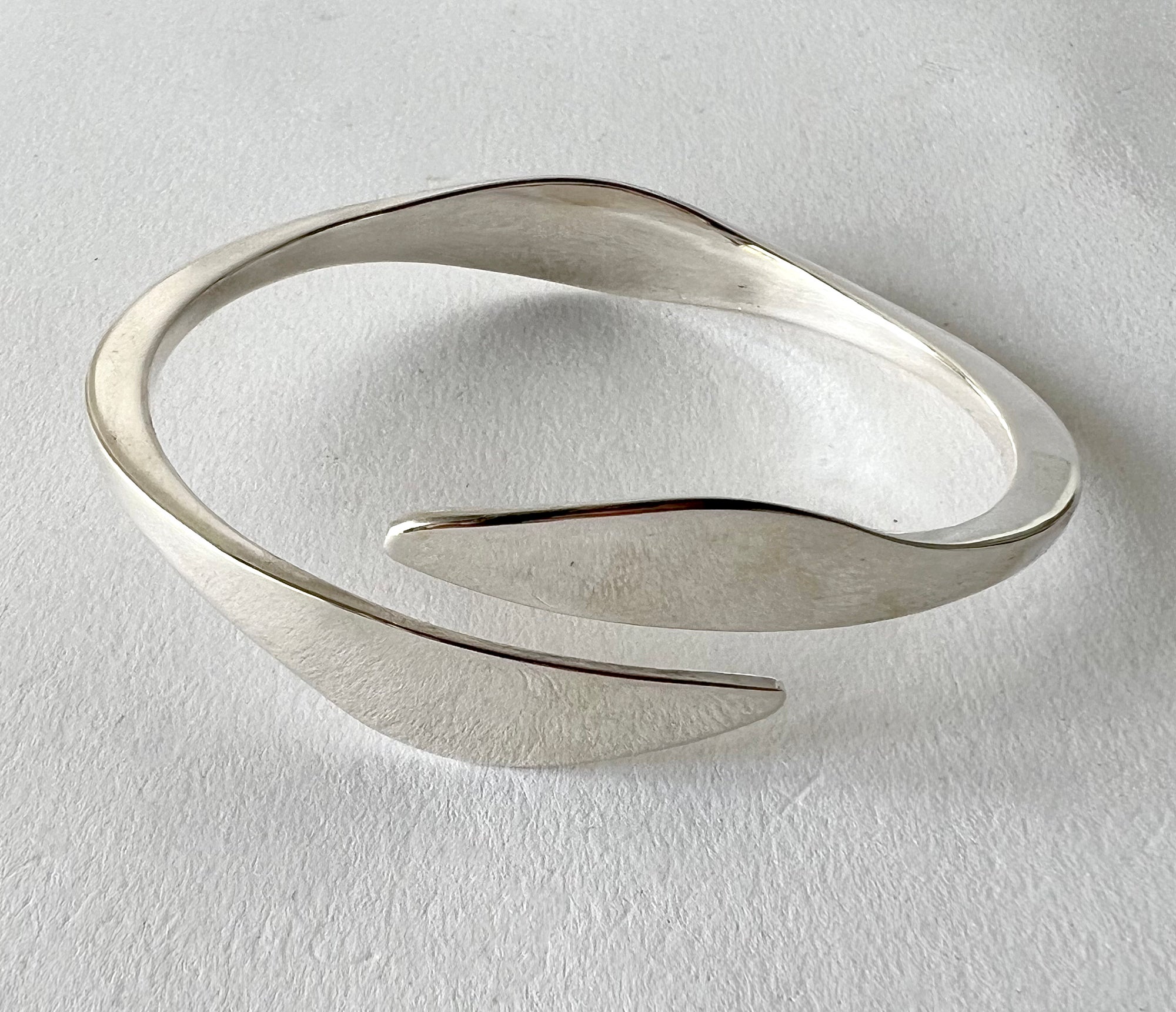 Sterling silver bangle cuff bracelet created by Ronald Hayes Pearson of Rochester, New York.  Bracelet measures and is signed Pearson, Sterling. Suitable for a man or woman and in very good vintage 1950's condition.  

The following was taken from
