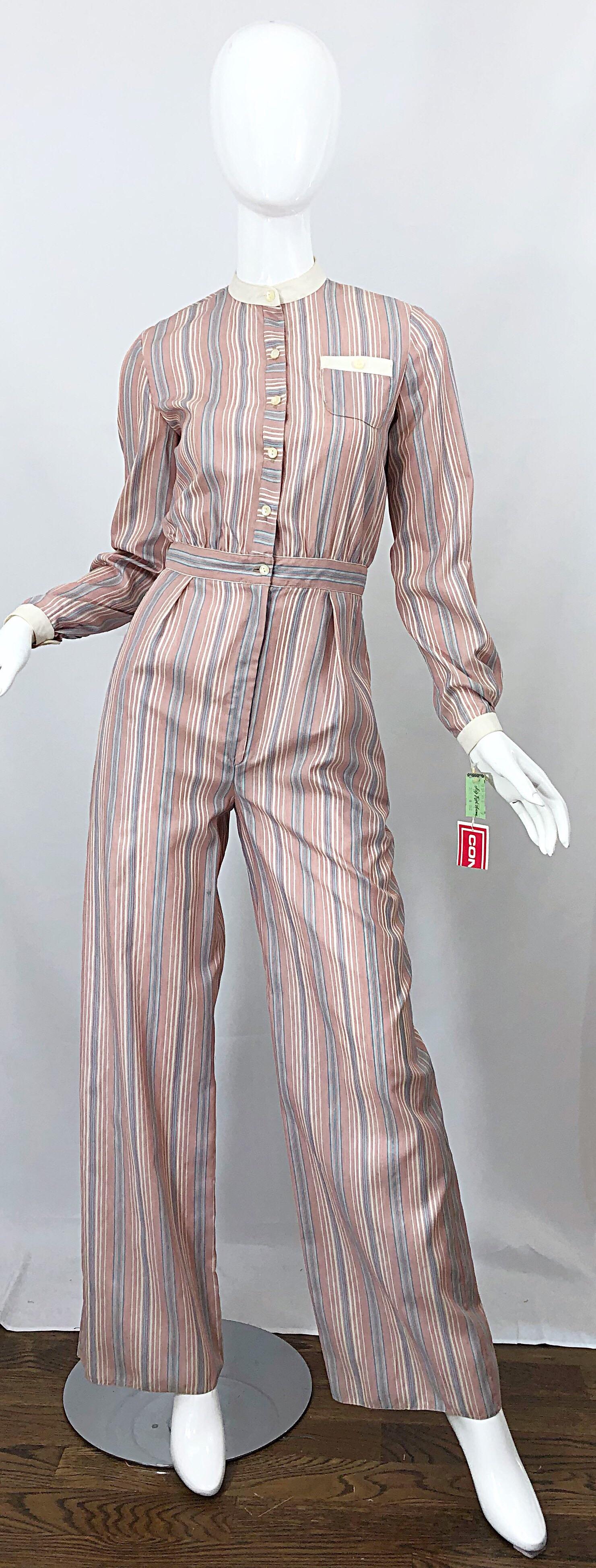 Stylish brand new with original SAKS 5th AVENUE store tags attached RONALD KOLODZIE striped one piece jumpsuit! Features blue and rose pink stripes throughout. Sleek fitted bodice buttons up the front. Comfortable wide leg pants have pockets at each