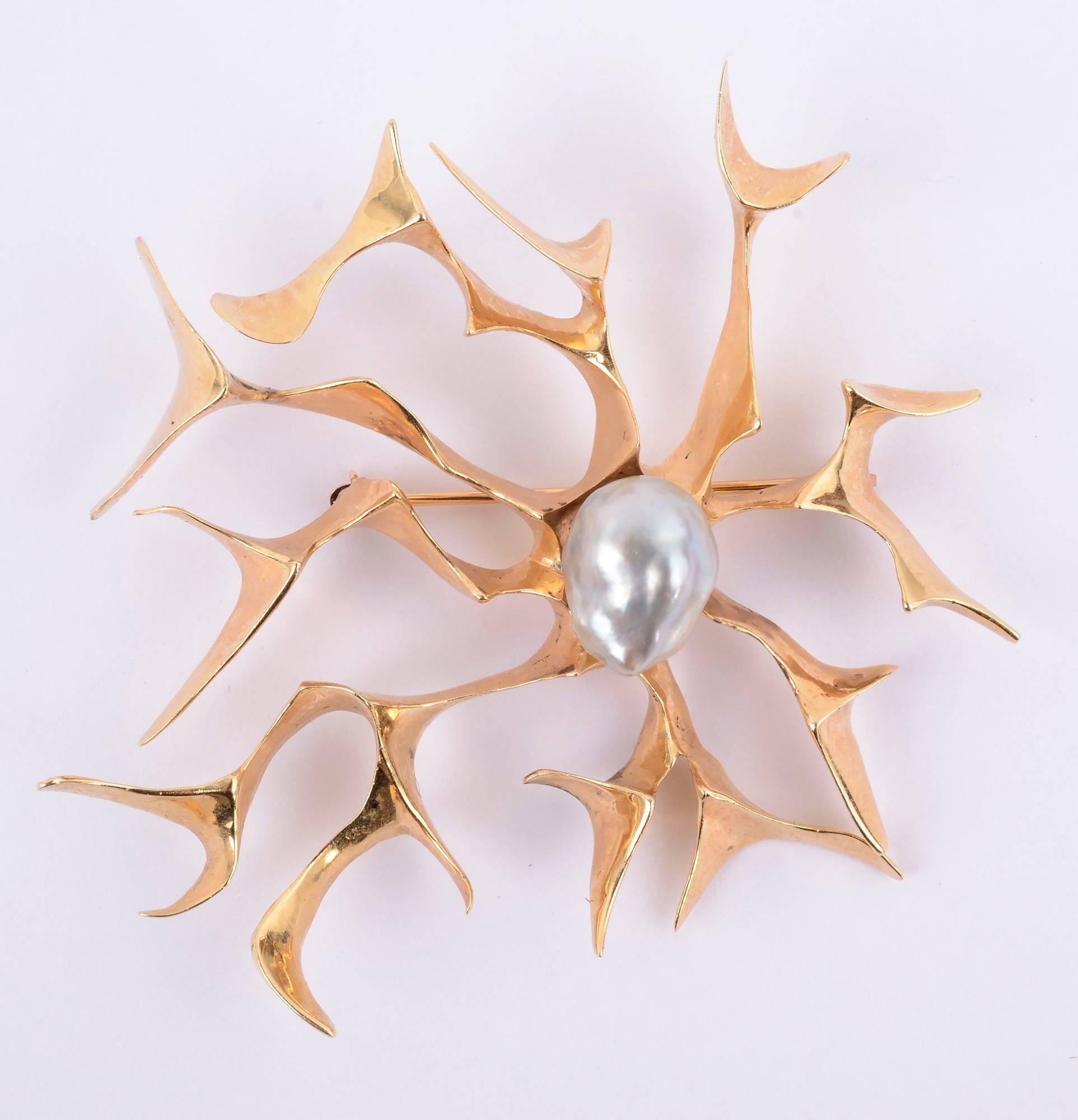 Freeform brooch and matching earrings by late  modernist designer, Ronald Pearson. Pearson was one of America's most highly esteemed art jewelry makers of the mid-20th century. 
The 14 karat brooch and earrings are open and airy. The brooch measures