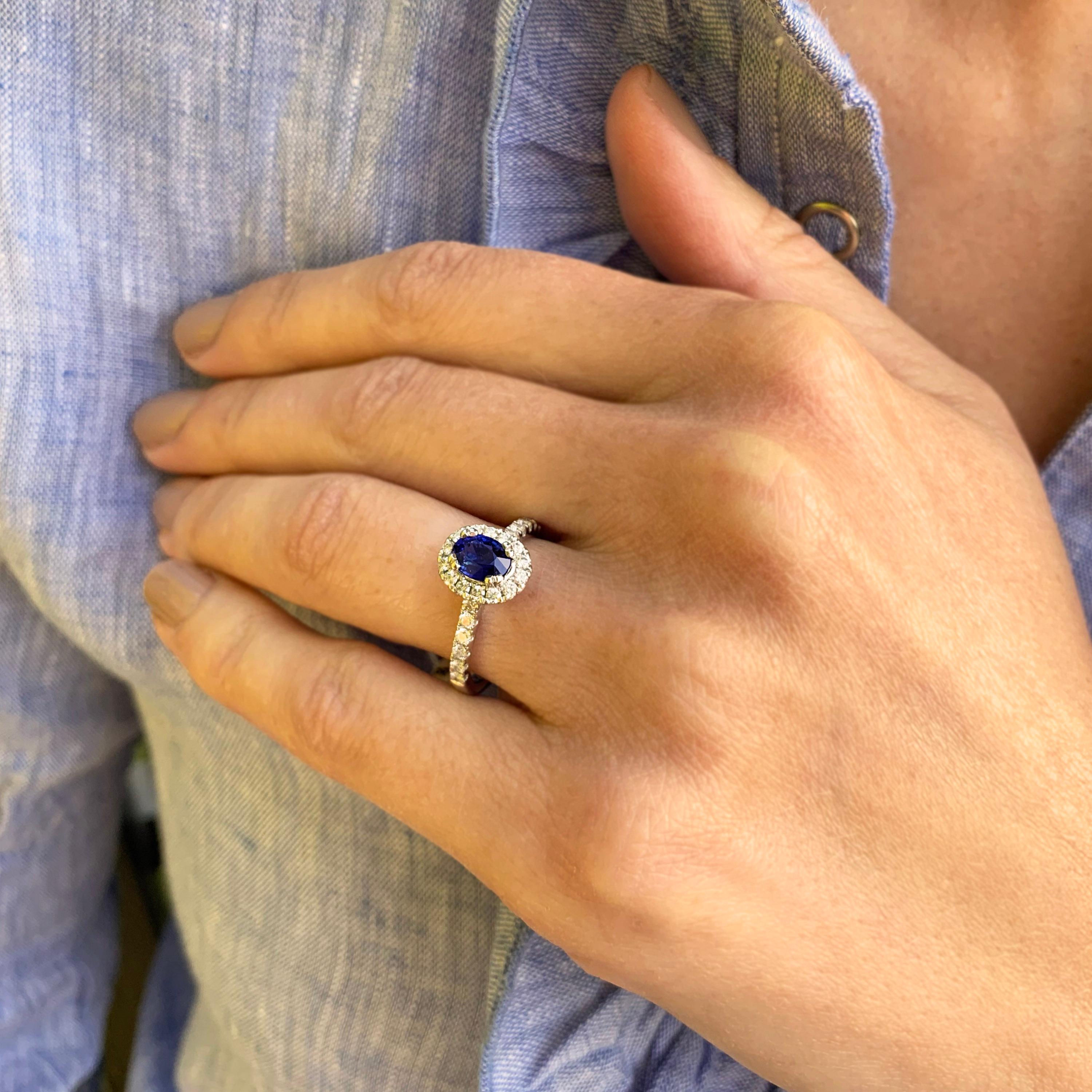 An elegant halo design holding a vibrant blue sapphire (1.02ct) in 18k white gold. Surrounded by castelle set round brilliant diamonds (0.45ct F VS2). Crafted so a wedding ring can slip neatly underneath without the need for a curve
Ring Size: M.