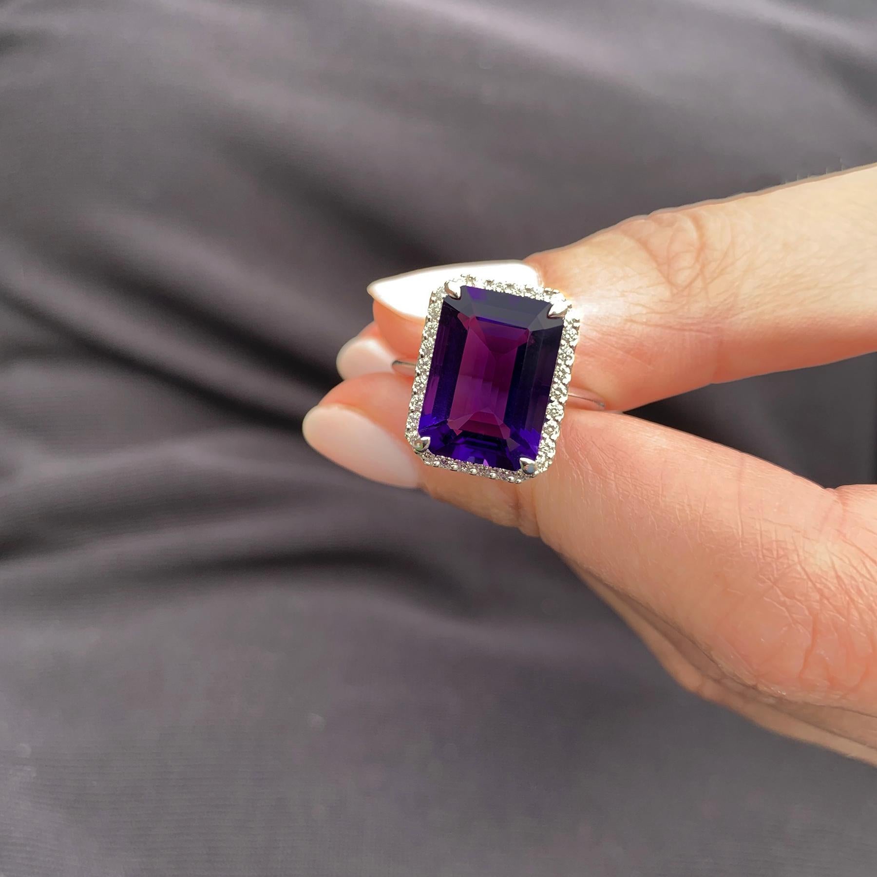 A deep purple rectangular amethyst sits perfectly framed by exquisitely scintillating round brilliant cut diamonds crafted in 18 karat white gold. An impressive but very elegant cocktail ring.

1 Step Cut Amethyst 6.00 carat
30 Round Brilliant Cut