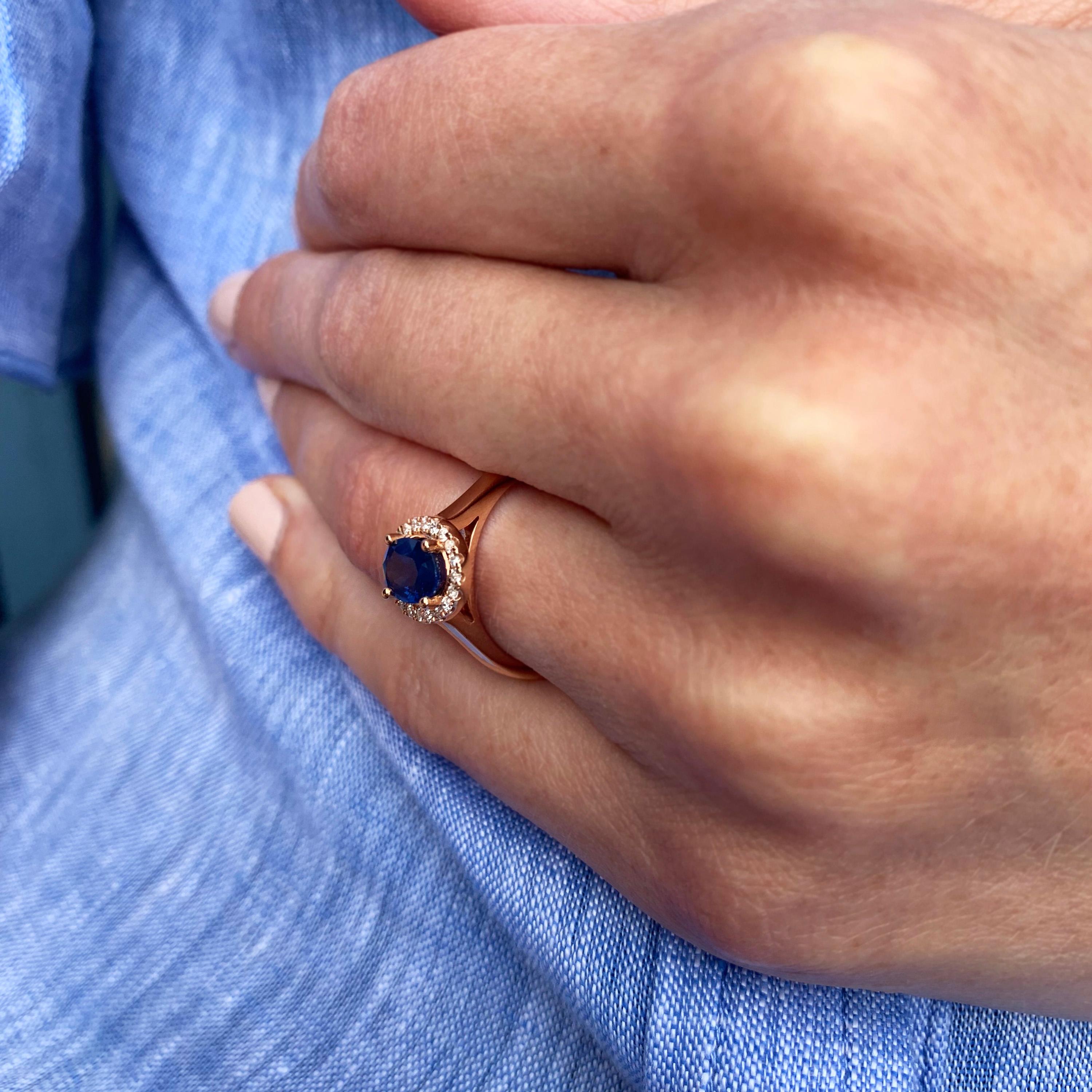 Handmade in 18k rose gold a unique engagement ring. Uniquely set in all 18k rose gold, this combination of deep blue and scintillating diamonds works so well. The oval sapphire (1.35ct) is framed perfectly by beautiful diamonds (0.13ct). Perfect as