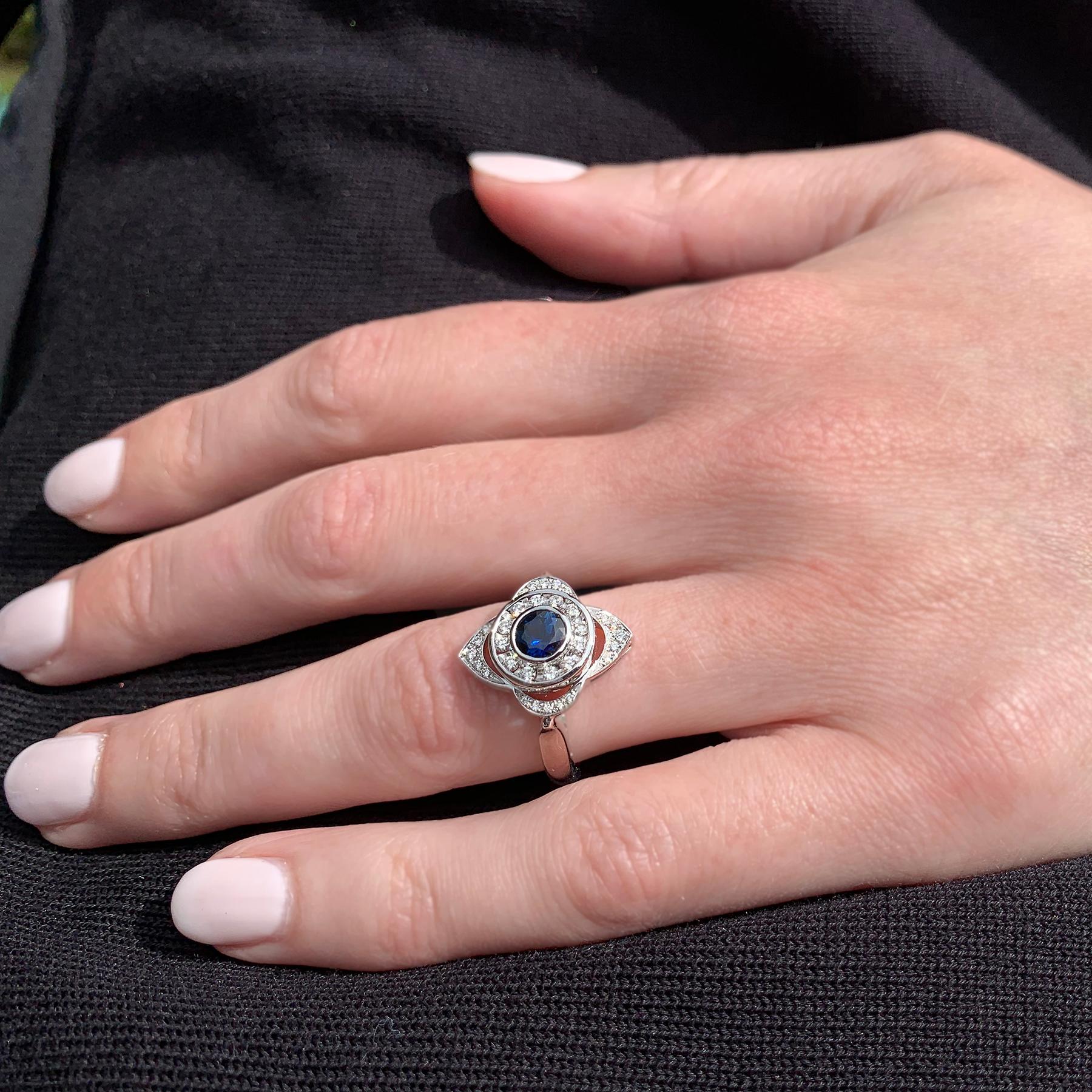 This exquisite sapphire and diamond ring could be an alternative engagement ring or a dress ring. A vibrant round cut blue sapphire is neatly bezel set and surrounded by exquisite round brilliant cut diamonds.

1 Deep blue round cut sapphire 4.8mm