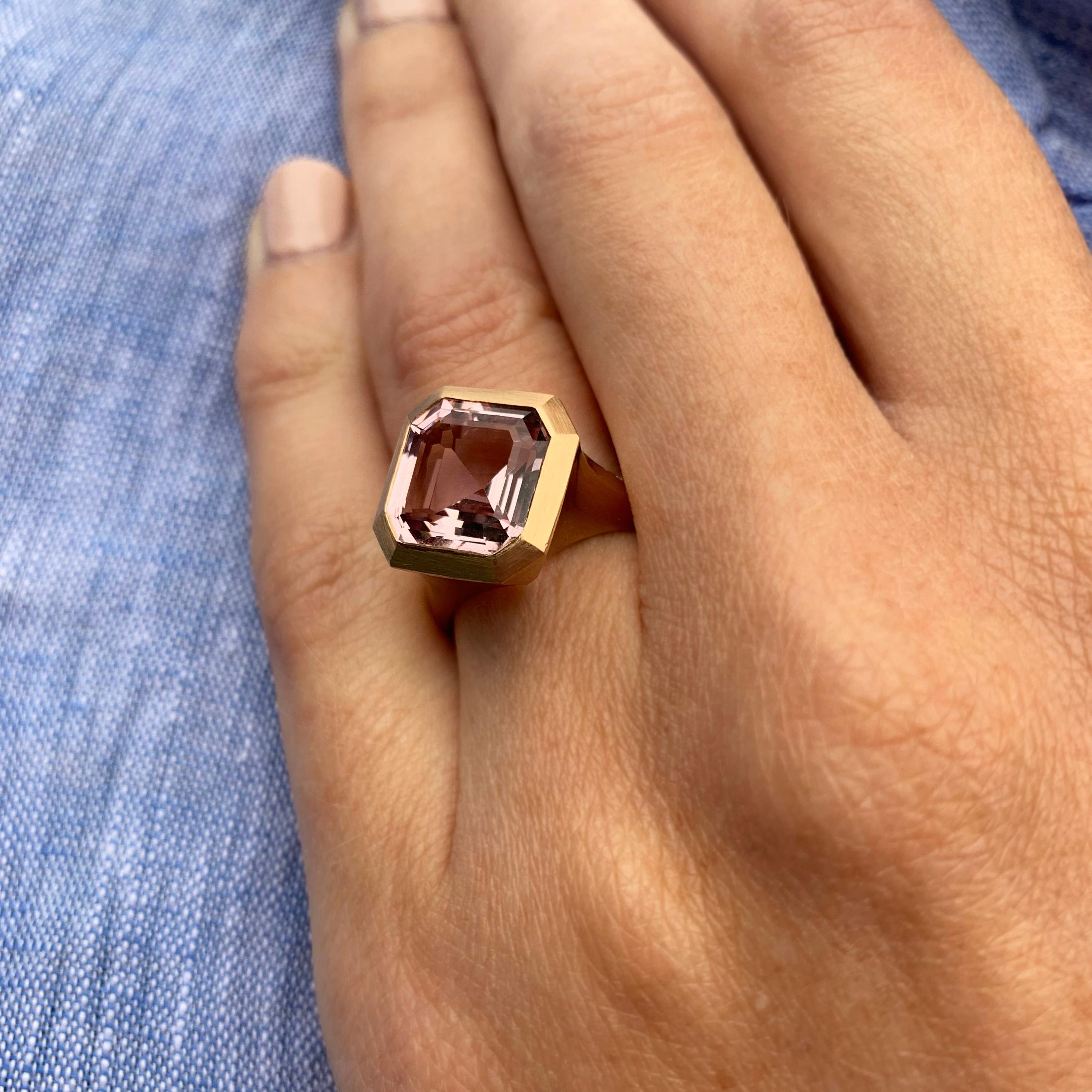 A true statement ring handmade from 18 karat rose gold, a beautiful vibrant soft pink morganite in a step cut or asscher style is perfectly bezel set into this impressive ring. One wall of this piece is set with stunning white diamonds so you can