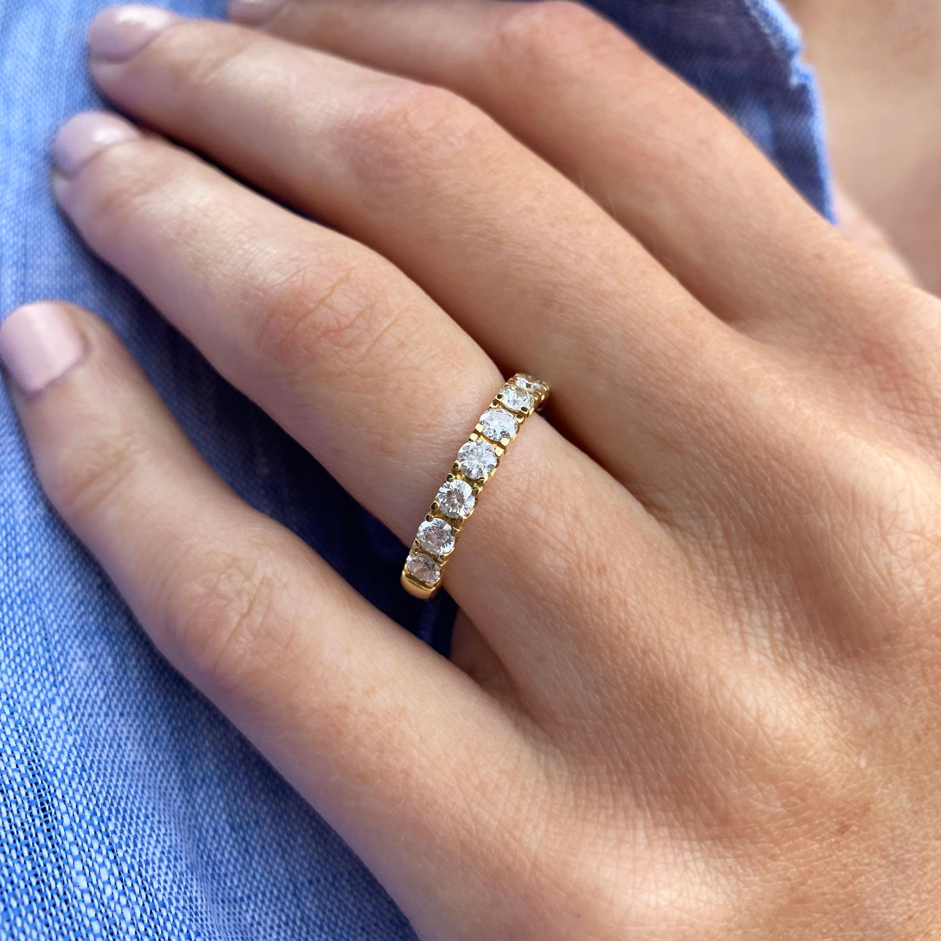 Modern classic diamond engagement, wedding or eternity ring. A classic diamond band crafted in yellow gold, each setting in meticulously defined set with ten round brilliant cut diamonds (1.00ct). The beautiful contrast between the warm 18k yellow