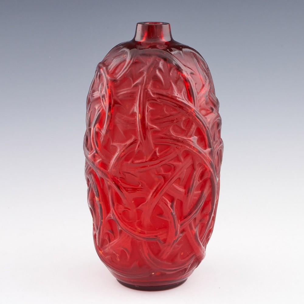 An Art Deco frosted glass vase by Rene Lalique designed in 1921. Red glass with twisted thorny briars raised decoration.  Stencil etched R Lalique France to base. 
