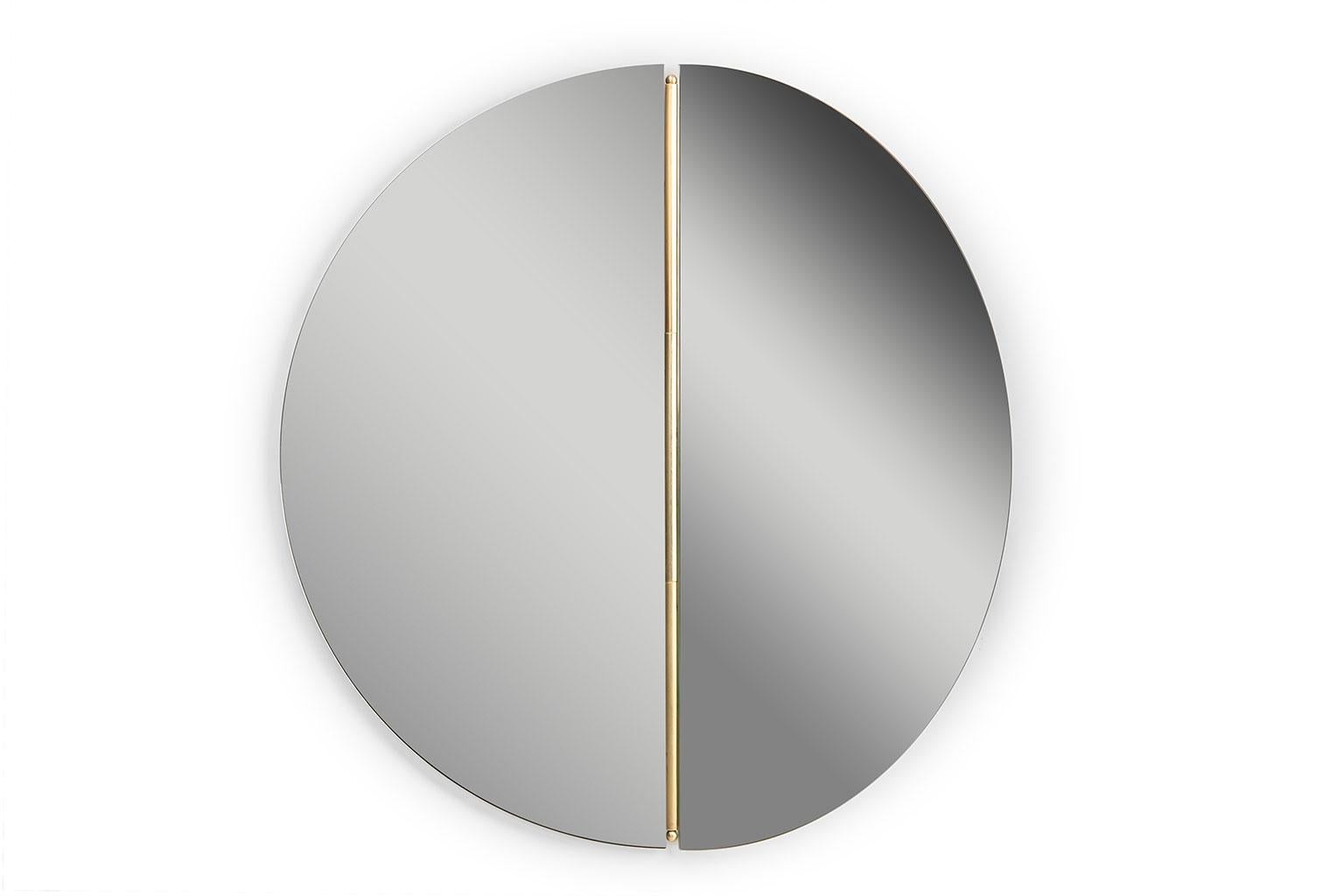 Rondo mirror designed by Bernhardt-Vella for Mingardo. Rondò reinterprets the Classic round mirror to accommodate it to any domestic environment, whether it is a living area, bedroom or bathroom. The half portion of the mirror can be adjusted so