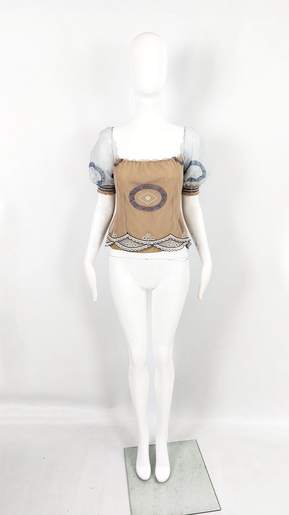 A super cute vintage womens top from the early 2000s by luxury British fashion designer, Ronit Zilkha. In a nude coloured fabric with a sheer mesh overlay and pastel blue mesh sleeves. The intricate embroidery adds a luxury ethereal / boho
