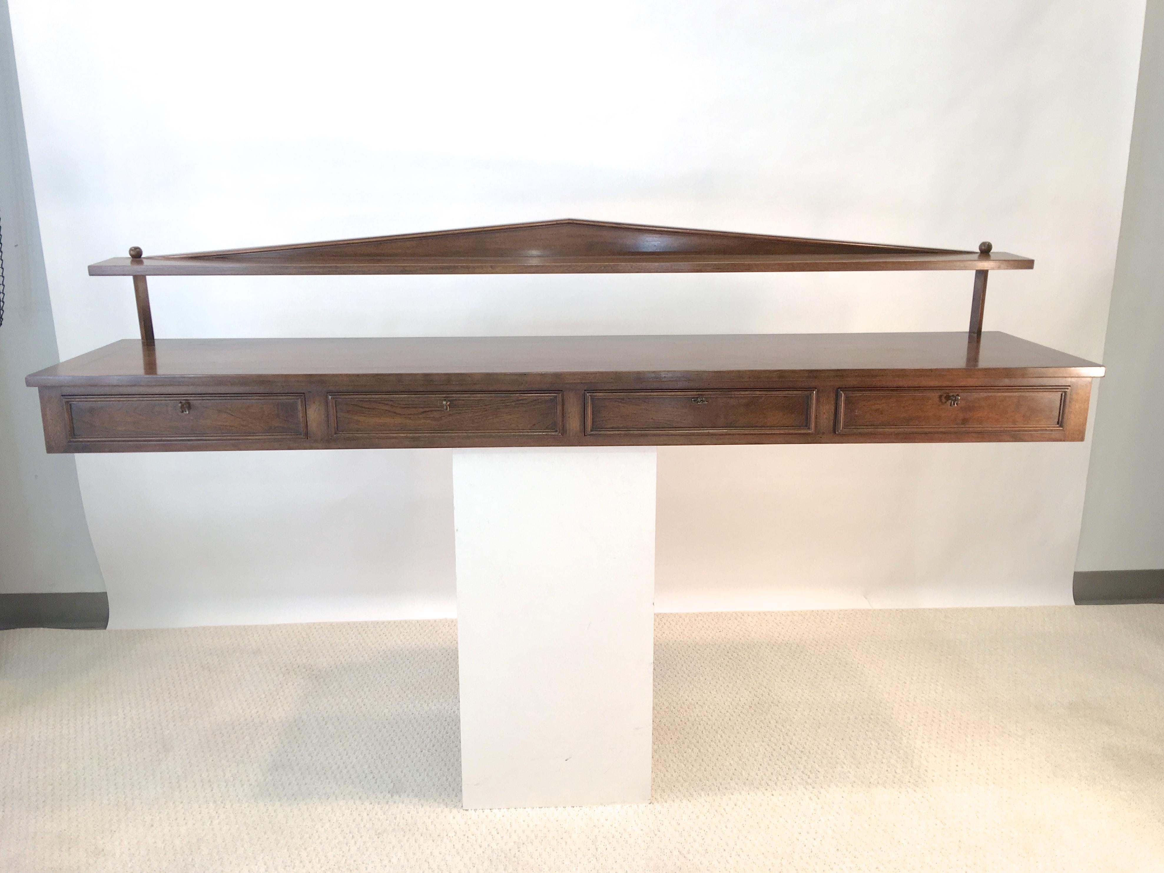 Gracious and at once both neoclassical and modern, this wall-mounted buffet console was designed by the late Ronnie Brahms and produced by the family owned furniture workshop of H. Sacks and Sons of Brookline, MA in the 1960s. Label inside first of