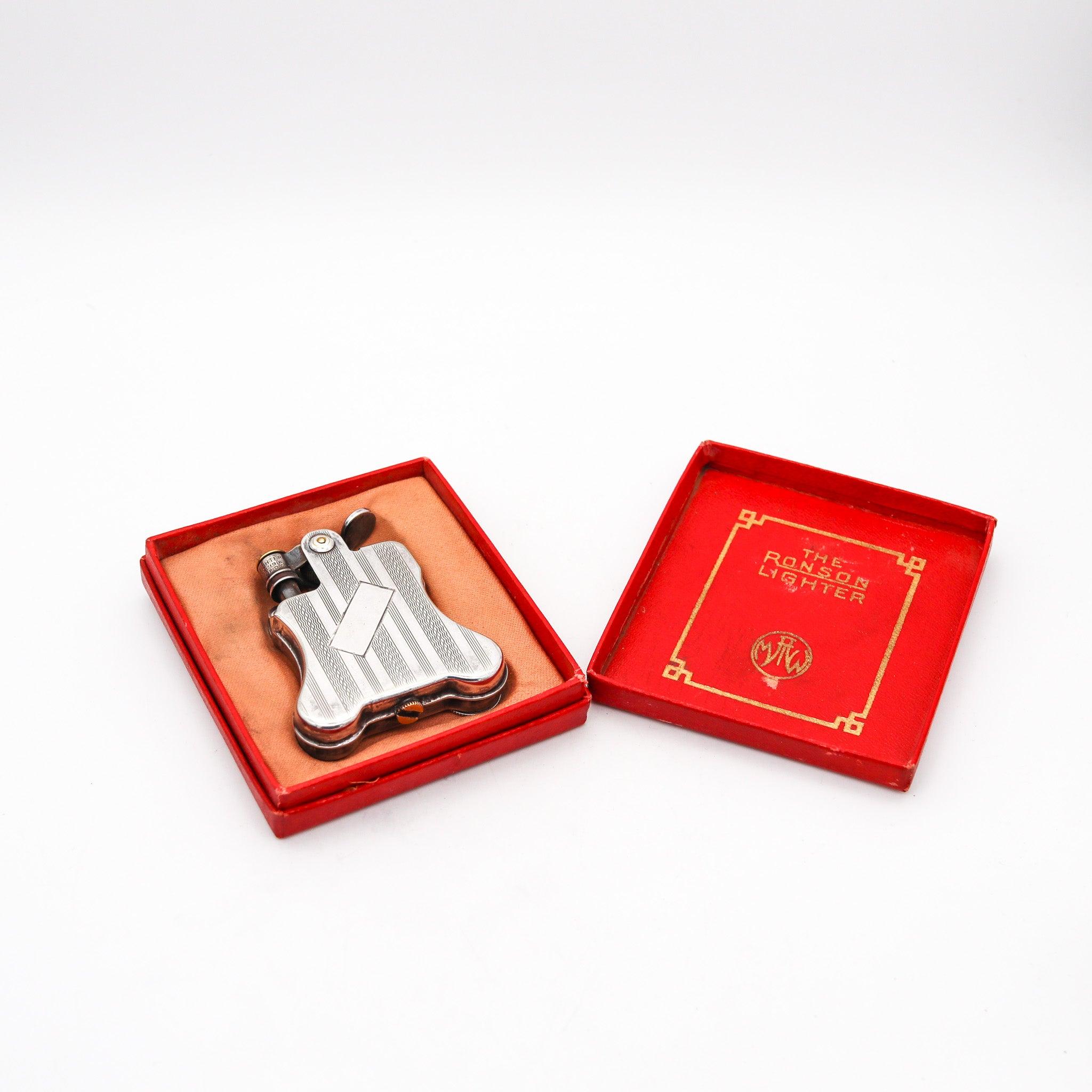 Banjo petrol lighter designed by Louis V, Aronson for Ronson.

This is an extremely rare and virtually in near mint condition with no traces of wear or usage, Banjo petrol pocket lighter designed by Louis V, Aronson for The Ronson Lighter Company.
