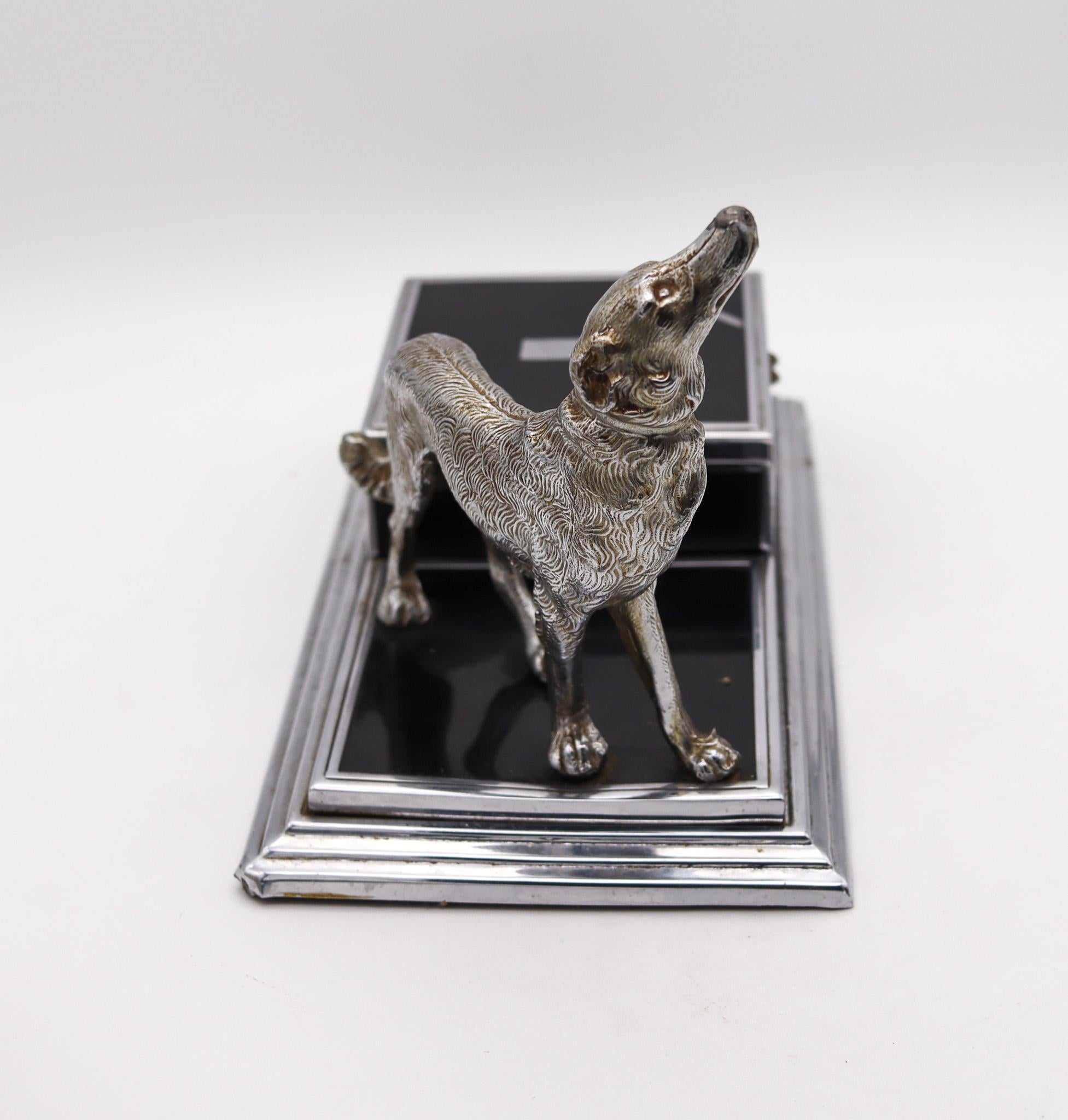 Desk cigarette box with dog designed by Jennings Brothers for Ronson.

Gorgeous desk box created by the Jennings Brothers Manufacturing Company and Ronson. This extremely rare piece has been crafted in solid chromed steel with a silver plated