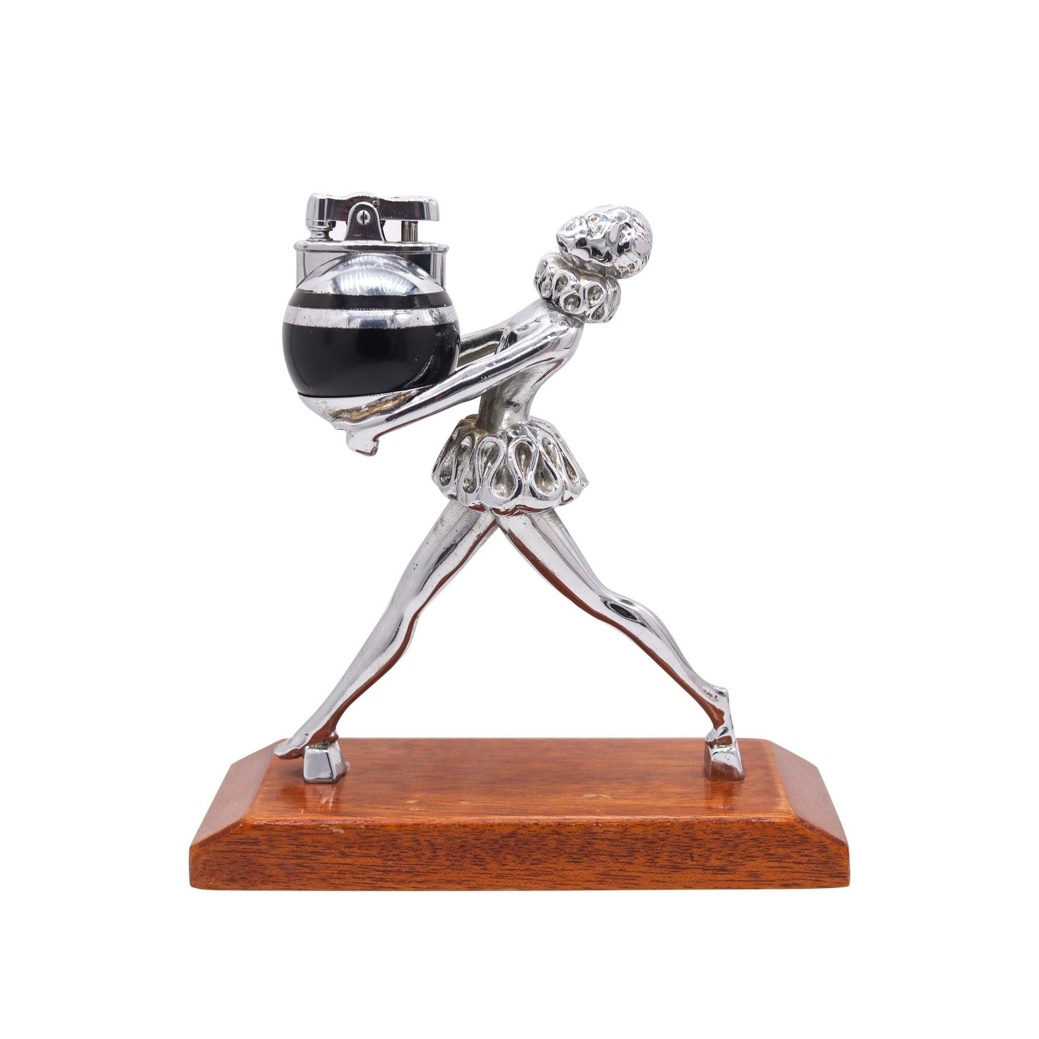 Ballerina figure with Ronde-Light lighter designed by Ronson.

This is a beautiful desk lighter, created in New Jersey United States by The Ronson Lighter Co. during the art deco period, back in the 1935. The piece is Ronson-16105, also known as the